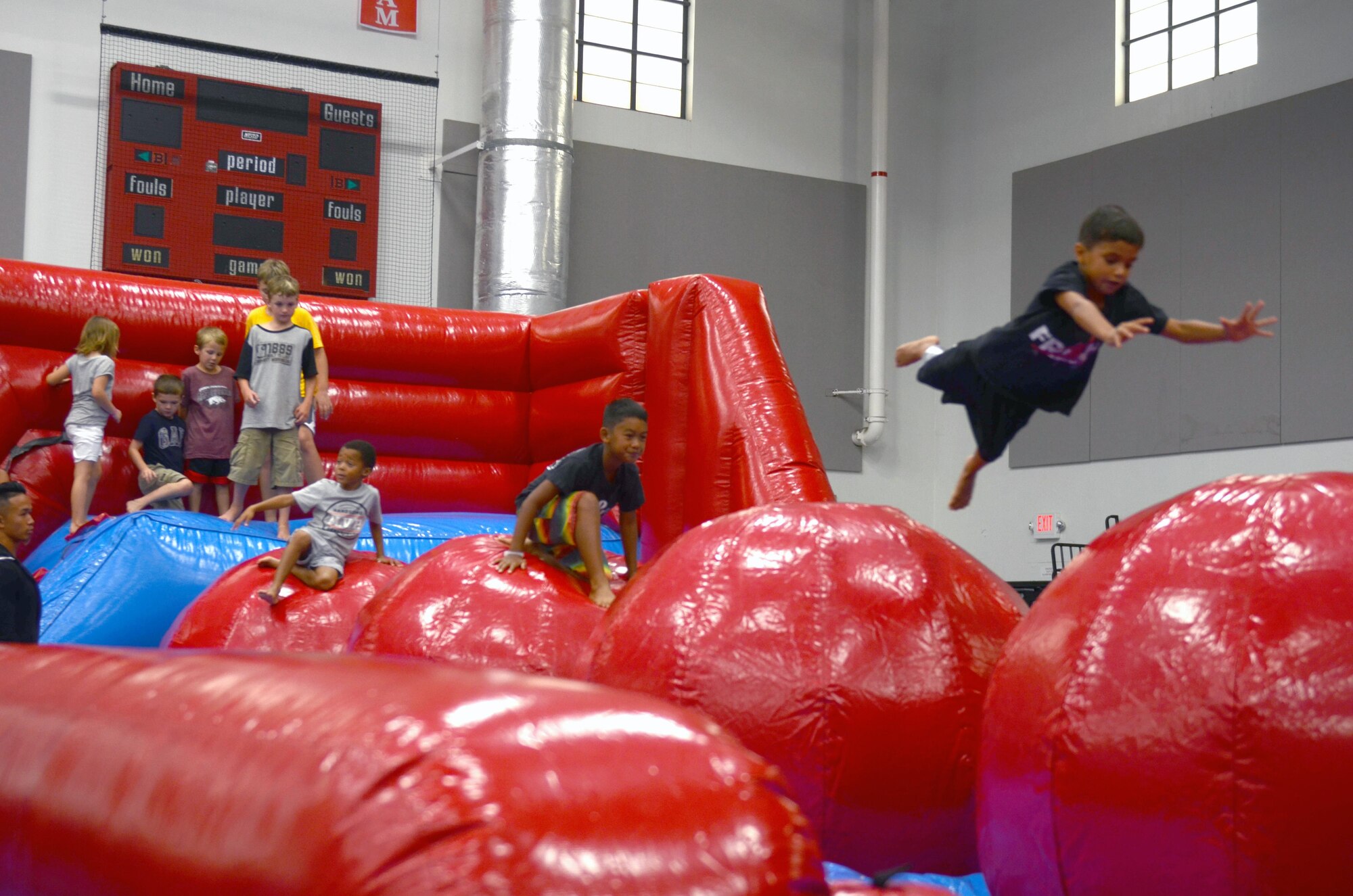 Children bounce around on an inflatable bounce house at Freedom Fest July 3, 2015, at Andersen Air Force Base. Freedom Fest 2015 included raffles, competitions, food, and a concert for Andersen Airmen and their families. (U.S. Air Force photo by Airman 1st Class Alexa Ann Henderson/Released)