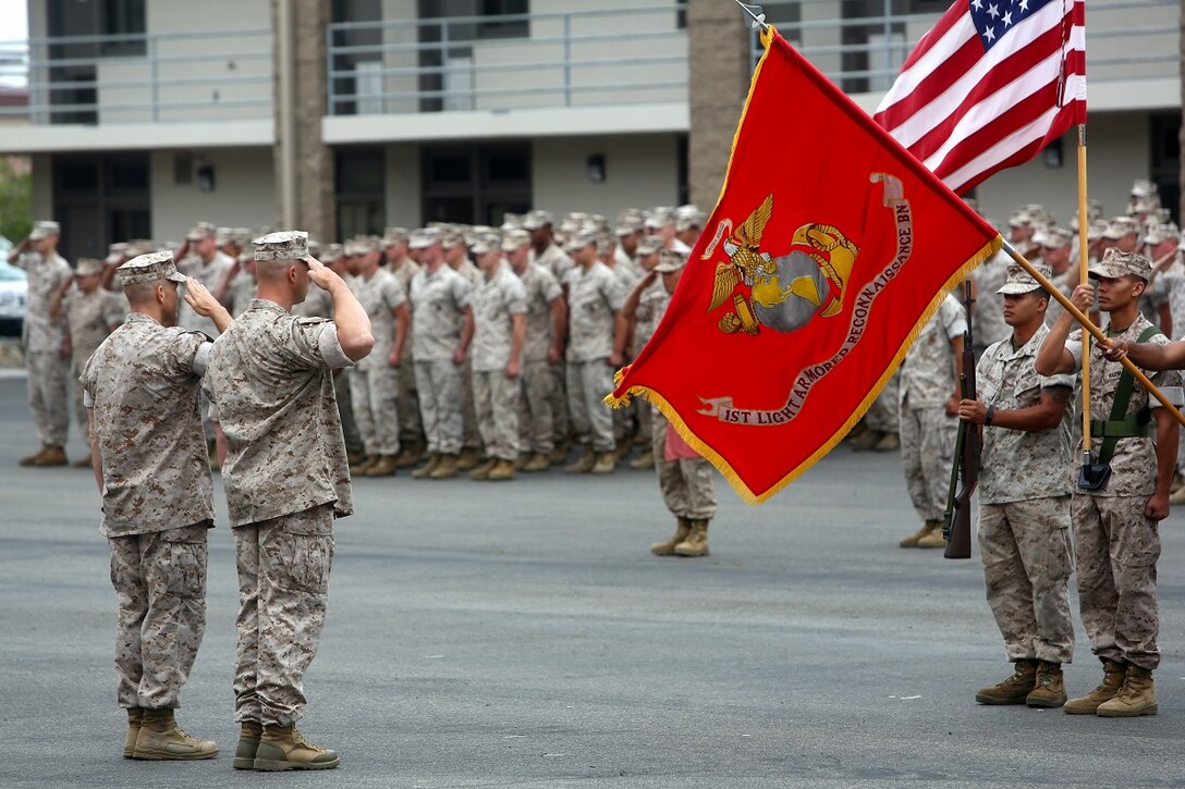 Lt. Col. Christian M. Rankin (right), commanding officer,1st Light Armored Reconnaissance Battalion, and Sgt. Maj. Steven M. Burkett (left), the battalion sergeant major, salute the national and organizational colors during the battalion’s 30th anniversary rededication ceremony, aboard Marine Corps Base Camp Pendleton Calif., July 1, 2015. After the ceremony, the Marines and Sailors of the battalion hiked to a nearby beach and held the annual Highlander Games Warrior Night. (U.S. Marine Corps photo by Staff Sgt. Bobbie A. Curtis)