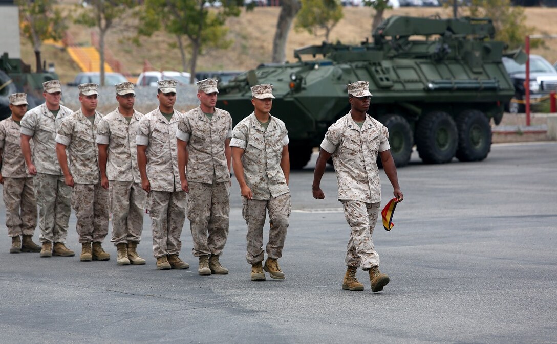 Marines with 1st Light Armored Reconnaissance Battalion, 1st Marine Division, line up to participate in the battalion’s 30th anniversary rededication ceremony aboard Marine Corps Base Camp Pendleton, Calif., July 1, 2015. The Marines each carried forth one of the battalion’s battle streamers to be placed upon the organizational colors by the commanding officer. (U.S. Marine Corps photo by Staff Sgt. Bobbie A. Curtis)