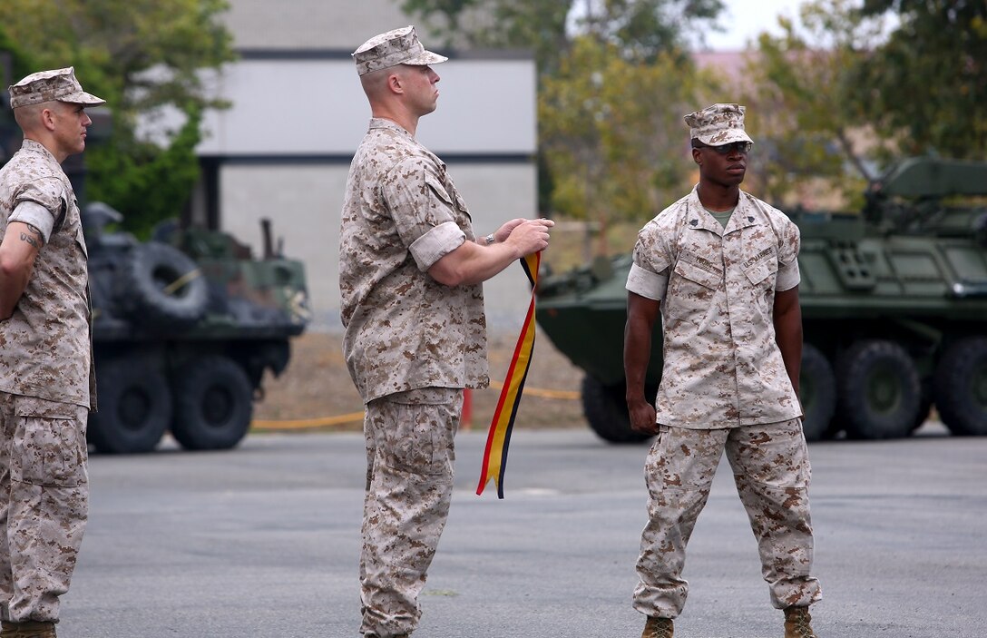 Lt. Col. Christian M. Rankin, commanding officer, 1st Light Armored Reconnaissance Battalion, prepares to place a battle streamer on the battalion’s organizational colors during the its 30th anniversary rededication ceremony, aboard Marine Corps Base Camp Pendleton, Calif., July 1, 2015. After the ceremony, the Marines and Sailors of the battalion hiked to a nearby beach and held the annual Highlander Games Warrior Night. (U.S. Marine Corps photo by Staff Sgt. Bobbie A. Curtis)