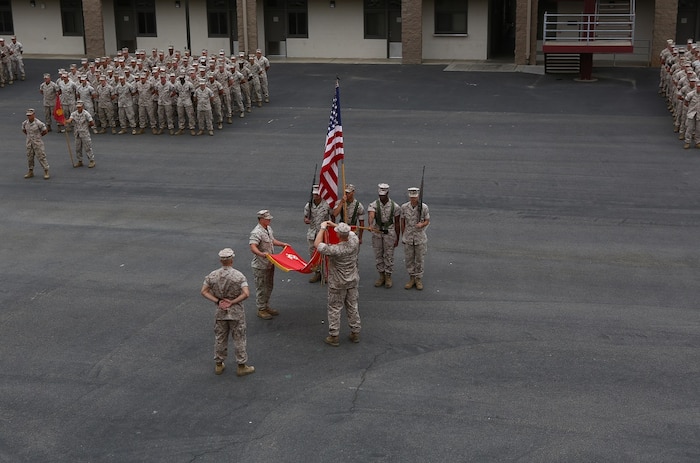 Lt. Col. Christian M. Rankin, commanding officer, 1st Light Armored Reconnaissance Battalion, places a battle streamer on the battalion’s organizational colors during the 30th anniversary rededication ceremony aboard Marine Corps Base Camp Pendleton, Calif., July 1, 2015. After the ceremony, the Marines and Sailors of the battalion hiked to a nearby beach and held the annual Highlander Games Warrior Night. (U.S. Marine Corps photo by Staff Sgt. Bobbie A. Curtis)