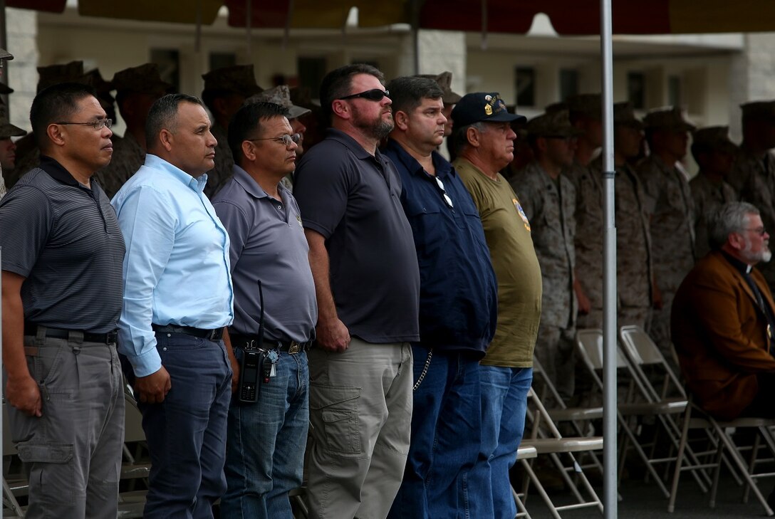 Veterans who served with 1st Light Armored Reconnaissance Battalion, 1st Marine Division, stand as the 1st Marine Division Song, Waltzing Matilda, is played during the battalion’s 30th anniversary rededication ceremony aboard Marine Corps Base Camp Pendleton, Calif., July 1, 2015. After the ceremony, the Marines and Sailors of the battalion hiked to a nearby beach and held the annual Highlander Games Warrior Night. (U.S. Marine Corps photo by Staff Sgt. Bobbie A. Curtis)