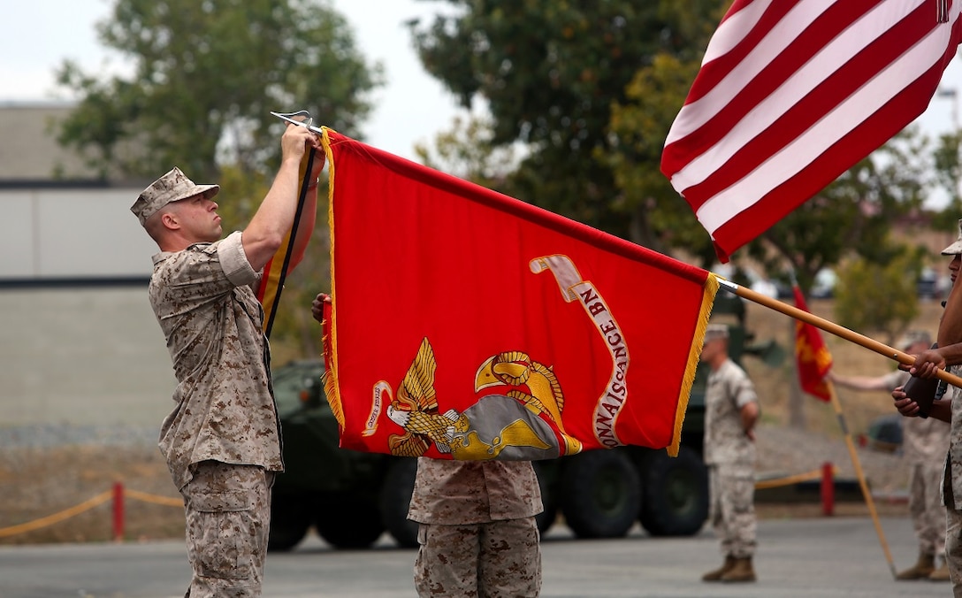 Lt. Col. Christian M. Rankin, commanding officer, 1st Light Armored Reconnaissance Battalion, places a battle streamer on the battalion’s organizational colors during the 30th anniversary rededication ceremony aboard Marine Corps Base Camp Pendleton, Calif., July 1, 2015. After the ceremony, the Marines and Sailors of the battalion hiked to a nearby beach and held the annual Highlander Games Warrior Night. (U.S. Marine Corps photo by Staff Sgt. Bobbie A. Curtis)