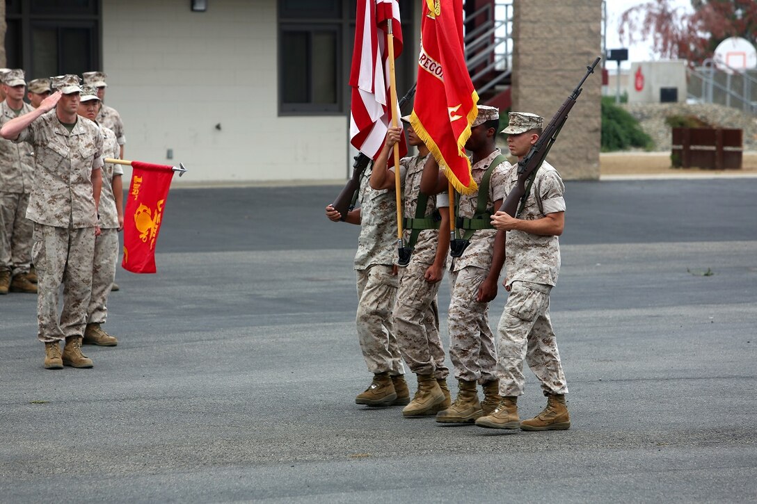 A company commander assigned to 1st Light Armored Reconnaissance Battalion, 1st Marine Division, salutes the national and organizational colors during the battalion’s 30th anniversary rededication ceremony aboard Marine Corps Base Camp Pendleton, Calif., July 1, 2015. After the ceremony, the Marines and Sailors of the battalion hiked to a nearby beach and held the annual Highlander Games Warrior Night. (U.S. Marine Corps photo by Staff Sgt. Bobbie A. Curtis)