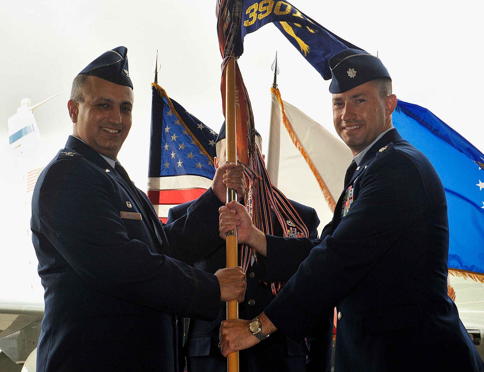 U.S. Air Force Col. Mohan Krishna, 55th Operations Group commander, Offutt Air Force Base, Neb., passes the 390th Intelligence Squadron guidon to Lt. Col. John Keys, 390th IS commander, during the squadron's change of command ceremony on Kadena Air Base, Japan, July 8, 2015. The change of command is a traditional military ceremony in which the departing commander assembles his troops for presentation to the incoming commander. Keys was the chief of the squadron and subsequently the director of operations of the 55th Intelligence Support Squadron at Offutt AFB before coming to Kadena. (U.S. Air Force photo by Naoto Anazawa)