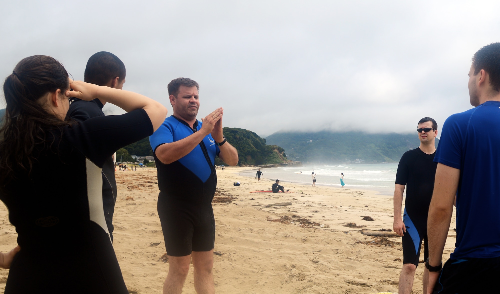 Capt. Patrick Poock, 374th Airlift Wing chaplain, speaks to Airmen about enriching their spirituality at Tadato Beach in Shimoda, Japan, June 27, 2015. As part of the Yokota’s Single Airman Program, Airmen had the opportunity to learn to surf and learn skills to learn to enhance their spirituality. (U.S. Air Force photo by Airman 1st Class Delano Scott/Released)
