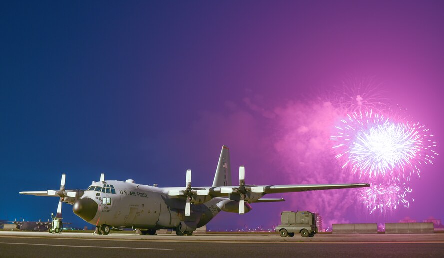 Fireworks explode behind a C-130 Hercules on the flightline during the finale of Celebrate America at Yokota Air Base, Japan, July 2, 2015. Celebrate America is hosted every year to celebrate America’s Independence Day and enhance esprit de corps. (U.S. Air Force photo by Senior Airman Michael Washburn/Released)