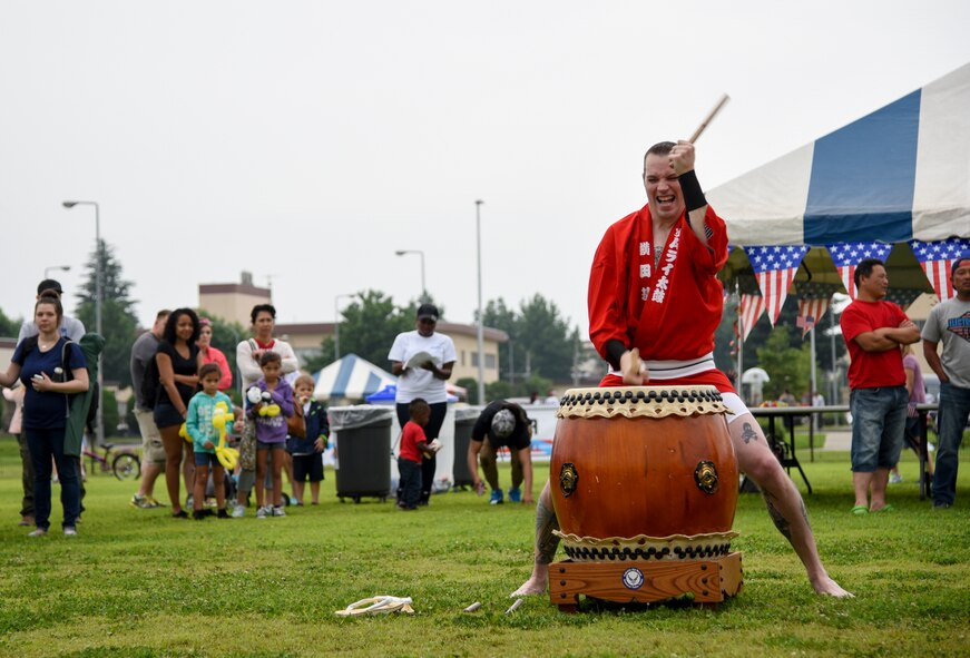 Master Sgt. Casey Hagen, 374th Maintenance Squadron, participates in a Taiko drum performance during Celebrate America at Yokota Air Base, Japan, July 2, 2015. The annual event provided military members and their families the opportunity to enjoy games, food and bands before culminating in a fireworks display to celebrate Independence Day. (U.S. Air Force photo by Senior Airman Michael Washburn/Released)