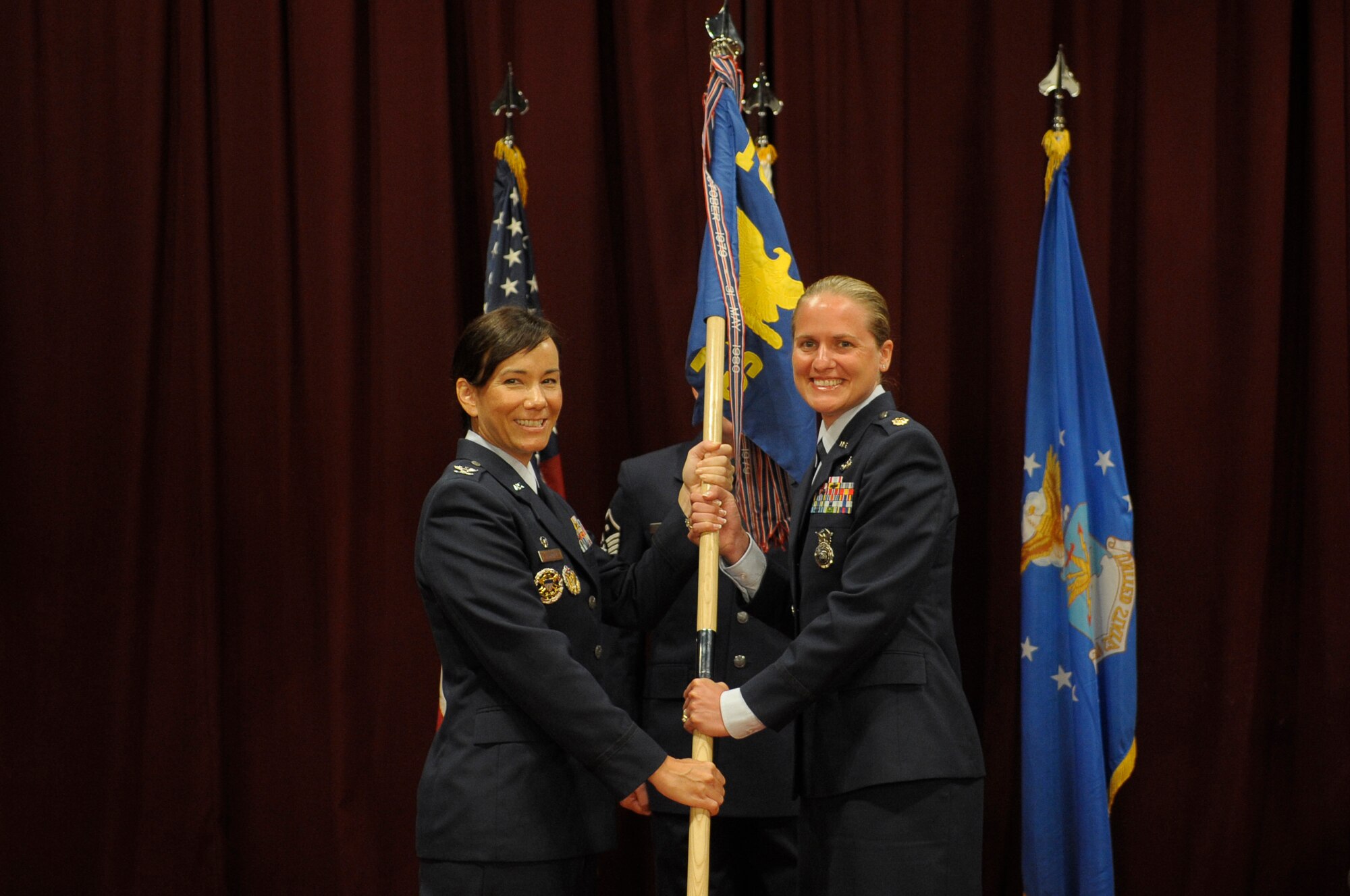U.S. Air Force Maj. Sarah S. Babbitt, newly appointed commander of the 18th Security Forces Squadron, accepts the 18th SFS guidon from Col. Debra A. Lovette, 18th Mission Support Group commander, during a change of command ceremony on Kadena Air Base, Japan, July 7, 2015. Babbitt is now responsible for leading the largest SFS in the Air Force, consisting of more than 450 Airmen, Soldiers, Sailors and local nationals. (U.S. Air Force photo by Airman 1st Class Zackary A. Henry)