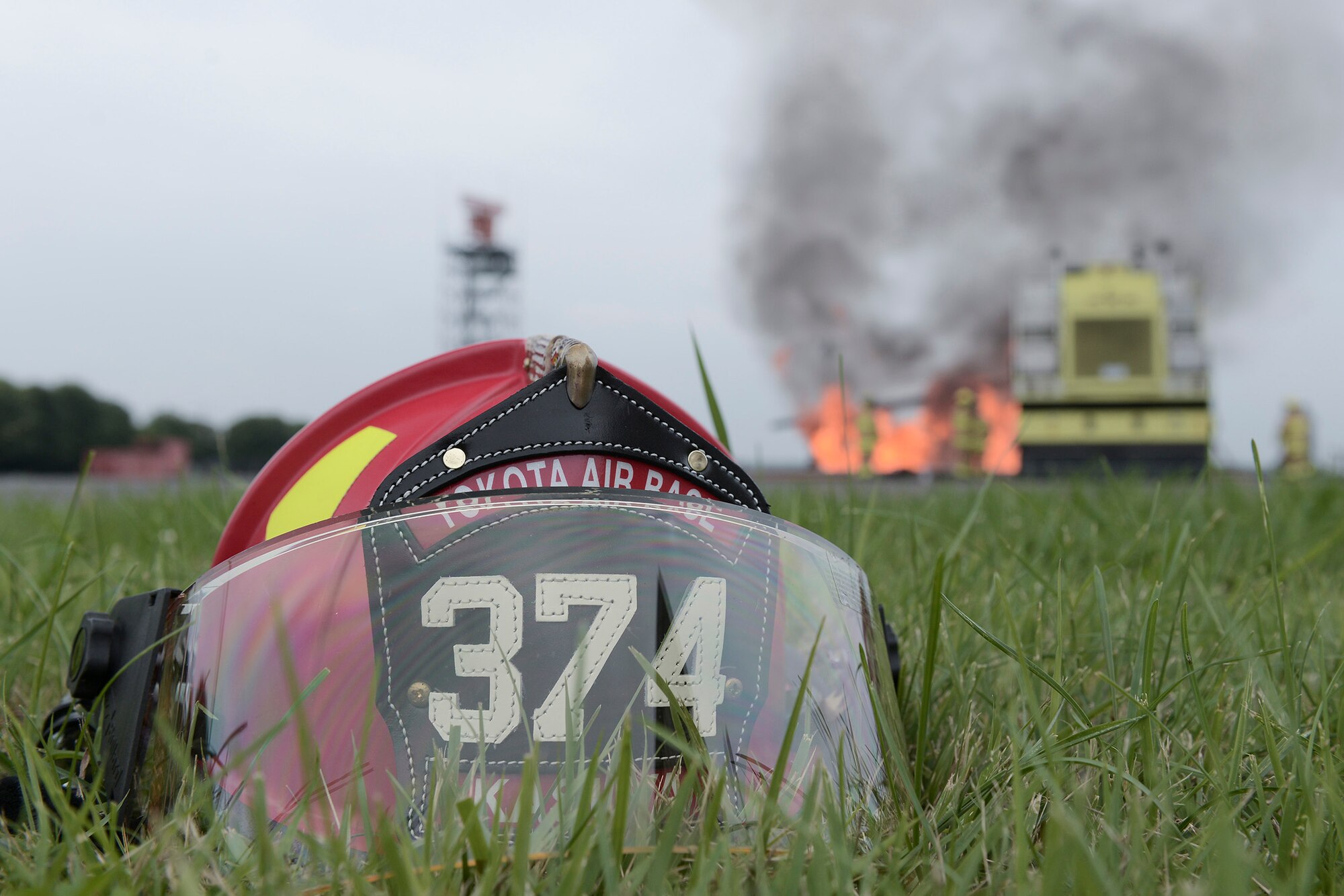 A 374th Civil Engineer Squadron fire protection helmet is set aside during live-fire training at Yokota Air Base, Japan, July 7, 2015. The owner of the helmet controlled the gas lines running to the fire training pit during the live-fire training. More than 20 members conducted the monthly training, preparing them to protect Yokota from fires year-round. (U.S. Air Force photo by Staff Sgt. Cody H. Ramirez/Released)  