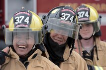 Fire protection members with the 374th Civil Engineer Squadron wait for live-life training to begin at Yokota Air Base, Japan, July 7, 2015. The members conduct this training monthly, keeping them ready to respond to fires at Yokota year-round. (U.S. Air Force photo by Cody H. Ramirez/Released)