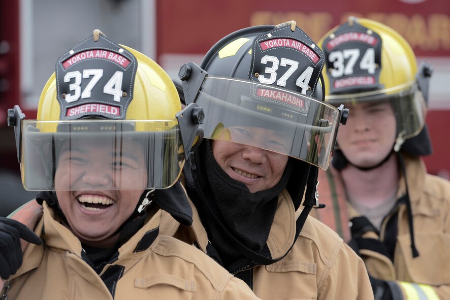 Fire protection members with the 374th Civil Engineer Squadron wait for live-life training to begin at Yokota Air Base, Japan, July 7, 2015. The members conduct this training monthly, keeping them ready to respond to fires at Yokota year-round. (U.S. Air Force photo by Cody H. Ramirez/Released)