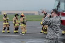 Tech. Sgt. Jeremy Hazel, 374th Civil Engineer Squadron fire protection assistant chief of operations, directs live-fire training at Yokota Air Base, Japan, July 7, 2015. More than 20 members from fire protection participated in the training to ensure readiness in preventing harm to life, limb or property at Yokota. (U.S. Air Force photo by Staff Sgt. Cody H. Ramirez/Released)