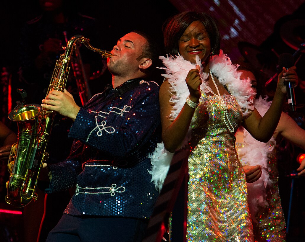 Senior Airman Javier Rodriguez blows the sax as Staff Sgt. Sherita Tisdom sings the blues during the Tops in Blues’ Independence Day show in the Cheyenne Frontier Days Arena, Cheyenne, Wyo., July 4, 2015. The 90-minute, high-energy show entertained an audience of several thousand prior to Cheyenne’s fireworks show. (U.S. Air Force photo by R.J. Oriez/Released) 
