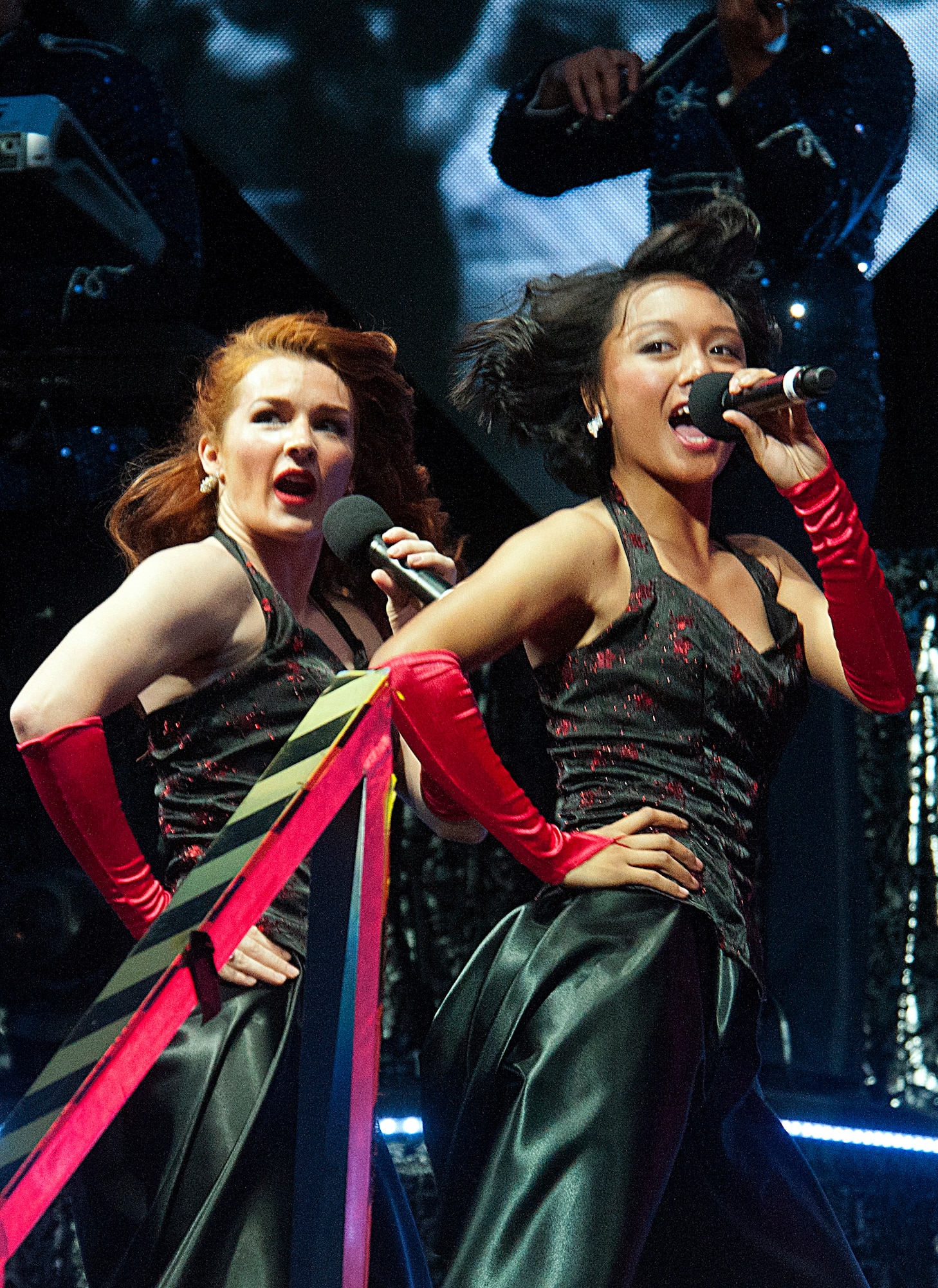 Airman 1st Class Christine Marie David (front), Tops in Blue member, sings while Staff Sgt. Marissa Strickland (back), fellow Tops in Blue member, backs her up in Frontier Park, Cheyenne, Wyo., July 4, 2015.  The Independence Day show was followed by a fireworks show. (U.S. Air Force photo by Senior Airman Jason Wiese)