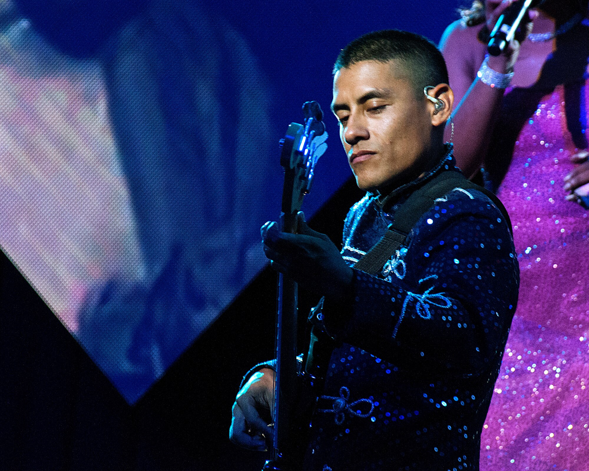 Tops in Blue’s Staff Sgt. Benny Casaverde strums the bass during a song in Frontier Park, Cheyenne, Wyo., July 4, 2015. Tops in Blue has performed in Cheyenne for four of the last five years, and it is becoming something of a tradition. (U.S. Air Force photo by Senior Airman Jason Wiese)