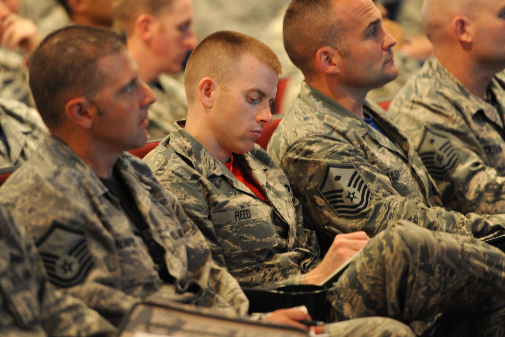 Master Sgt. Jeremy Reed, 509th Logistics Readiness Squadron first sergeant, takes notes during a briefing June 26, 2015, at Whiteman Air Force Base, Mo. The briefing discussed upcoming changes in the Enlisted Evaluation System and Weighted Airman Promotion System. (U.S. Air Force photo by Airman 1st Class Michaela R. Slanchik/Released)