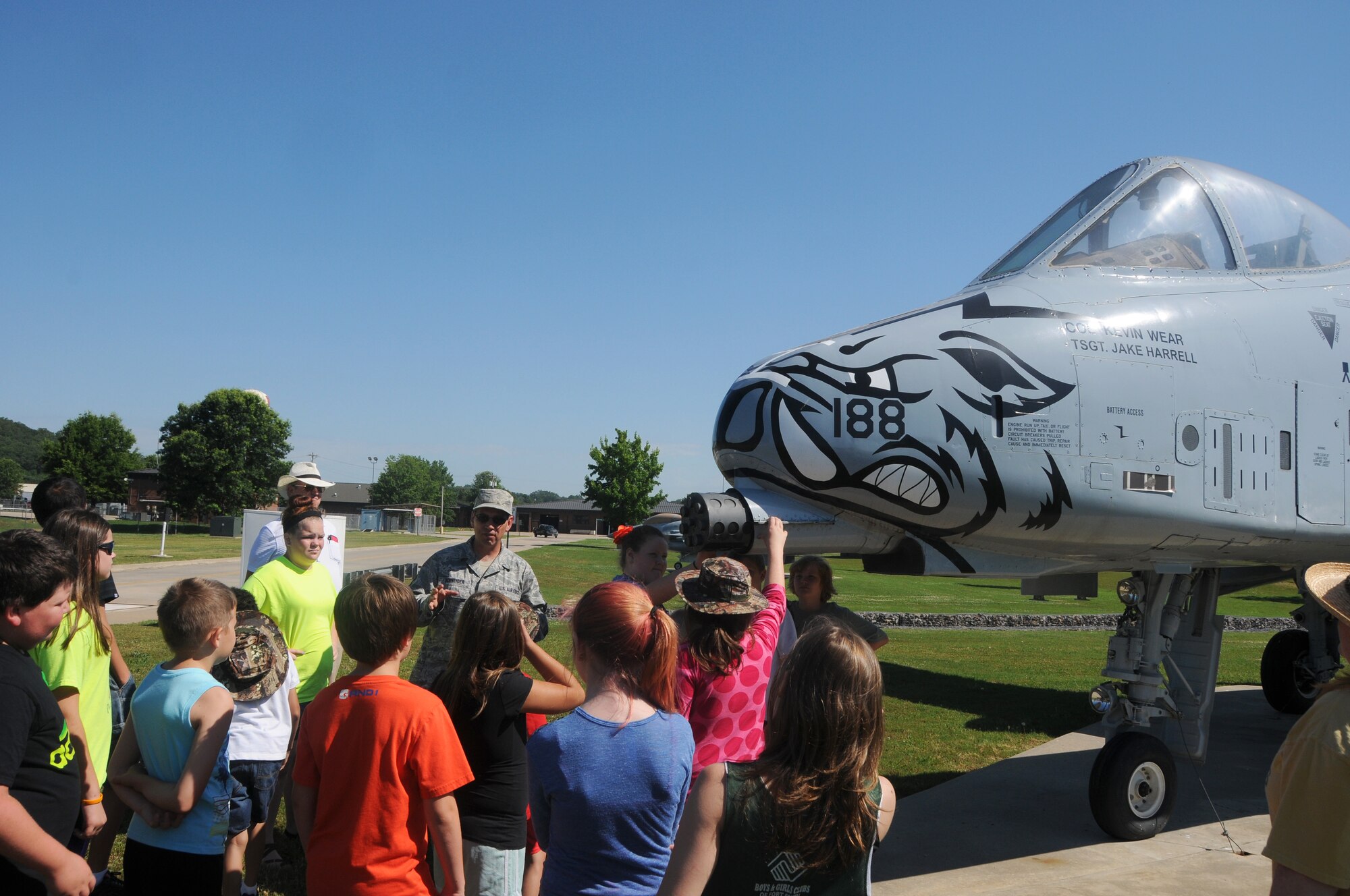 Senior Master Sgt. Carl Schneider, 188th Intelligence Support Squadron cyber systems superintendent, provides a history of the 188th Wing to students of the Alma School District at Ebbing Air National Guard Base, Ark., by showing its last aircraft, the A-10A Thunderbolt II "Warthog", June 11, 2015. The kids were able to see the statics of the aircraft the 188th used in previous missions and sat in briefings about the 188th Wing’s current mission before fishing in Ebbing Lake.  (U.S. Air National Guard photo by Senior Airman Cody Martin/Released)