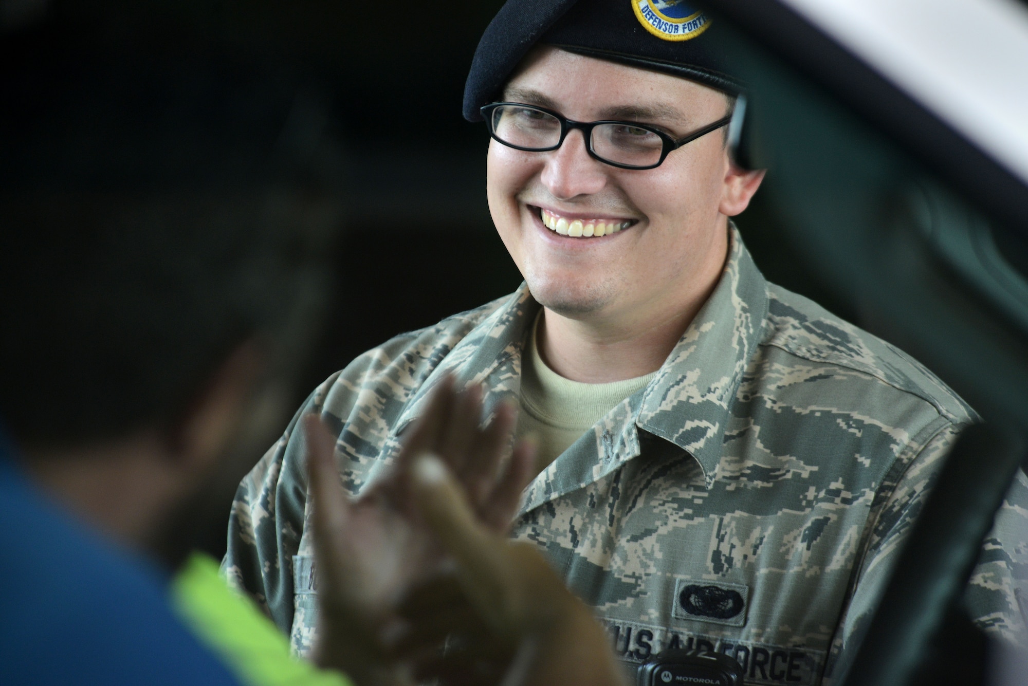 U.S. Air Force Senior Airman Sanchez Boyette, 20th Security Forces Squadron installation entry controller, engages with visitors at Shaw Air Force Base, S.C., July 1, 2015. Prepared for duty by 5 a.m., Boyette completed an eight-hour shift, helping to ensure the security of Team Shaw and their families. (U.S. Air Force photo by Airman 1st Class Kelsey Tucker/Released)