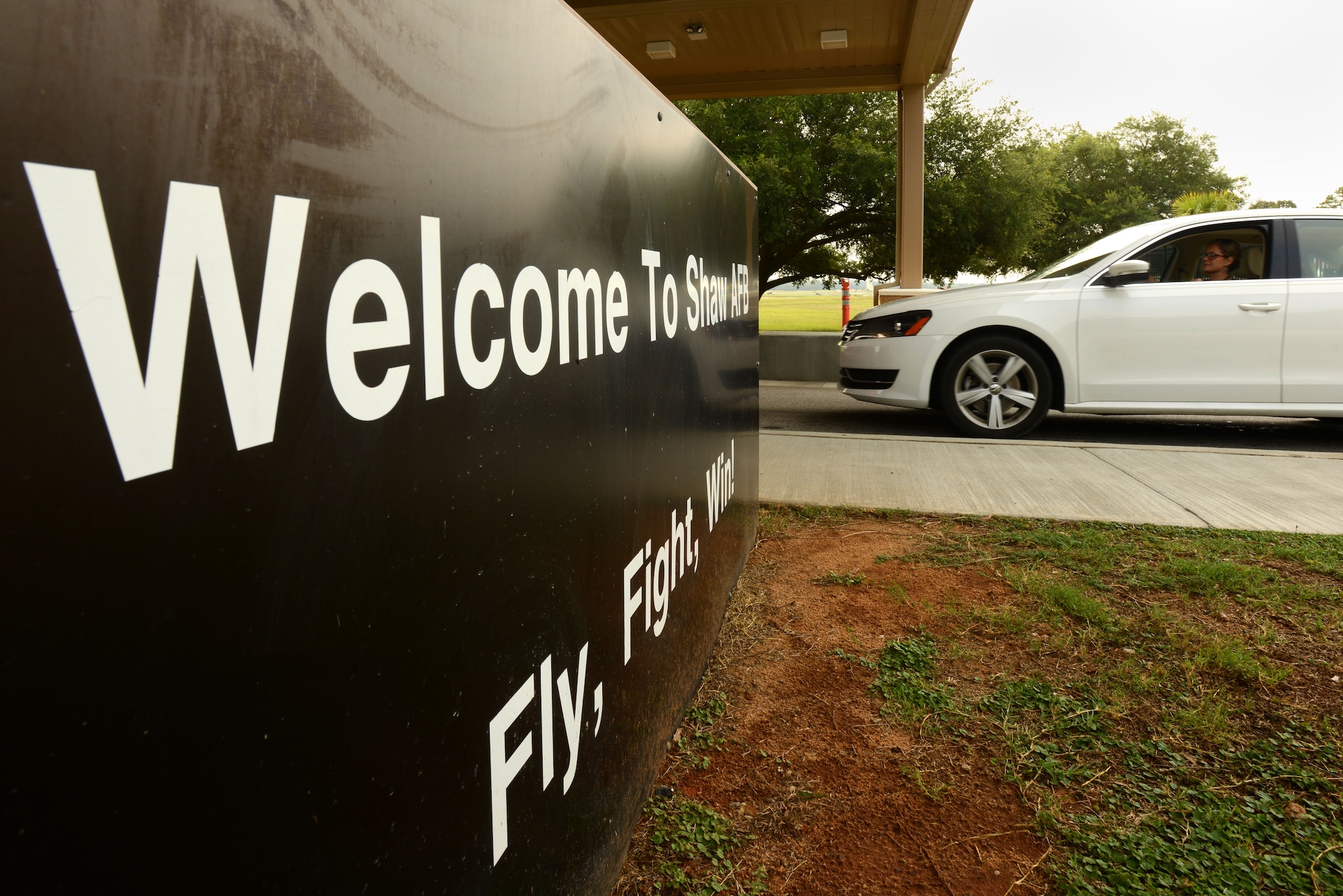 A sign at the main gate welcomes Team Shaw members and visitors to Shaw Air Force Base, S.C., July 1, 2015. 20th Security Forces Squadron Airmen keep the gate open and secure at all hours of the day. (U.S. Air Force photo by Airman 1st Class Kelsey Tucker/Released)