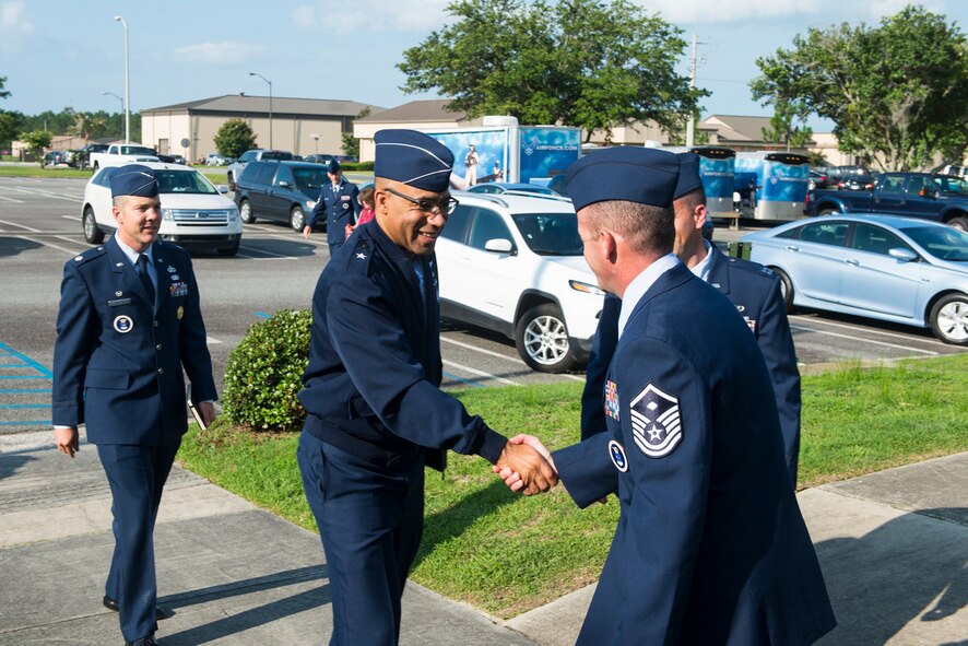 U.S. Air Force Brig. Gen. James Johnson, Air Force Recruiting Service commander, greets Airmen from the 336th Recruiting Squadron during his visit July 7, 2015, at Moody Air Force Base, Ga. Johnson commands approximately 2,600 Airmen and civilians and is responsible for more than 1,200 recruiting offices. While visiting Moody, Johnson toured the 336th RCS, hosted an office-call and coined four Airmen for their hard work despite the obstacles recruiting Airmen face. (U.S. Air Force photo by Airman 1st Class Ceaira Tinsley/Released)