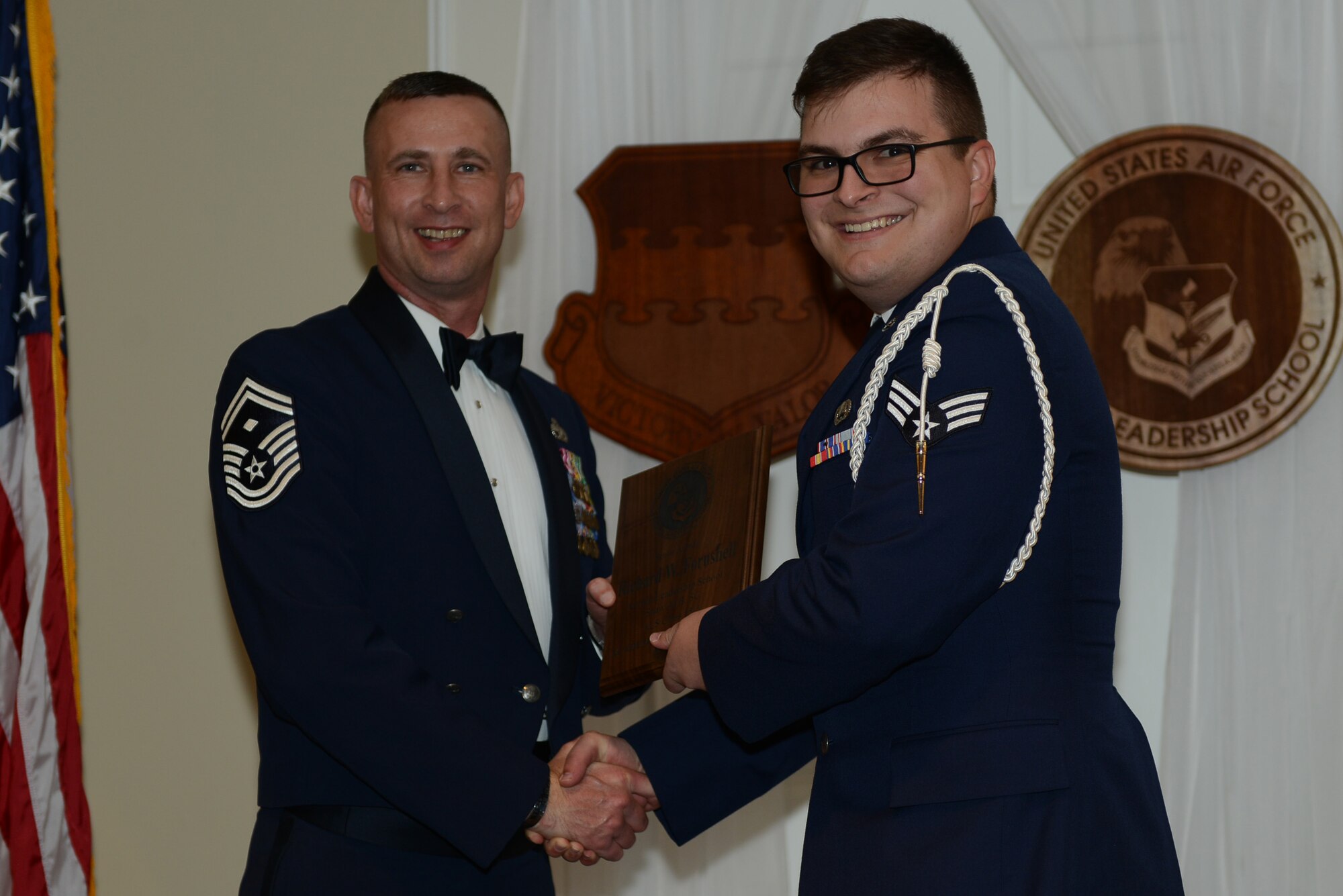 U.S. Air Force Senior Airman Richard Fornshell, 3rd Intelligence Squadron, receives the Senior Master Sgt. David B. Reid Airman Leadership School Academic Achievement award from Senior Master Sgt. Johnny Hamm, U.S. Air Forces Central first sergeant, during the ALS Class 15-5 graduation at Shaw Air Force Base, S.C., July 2, 2015. This award is given to the student with the highest point total. (U.S. Air Force photo by Senior Airman Diana M. Cossaboom/Released)