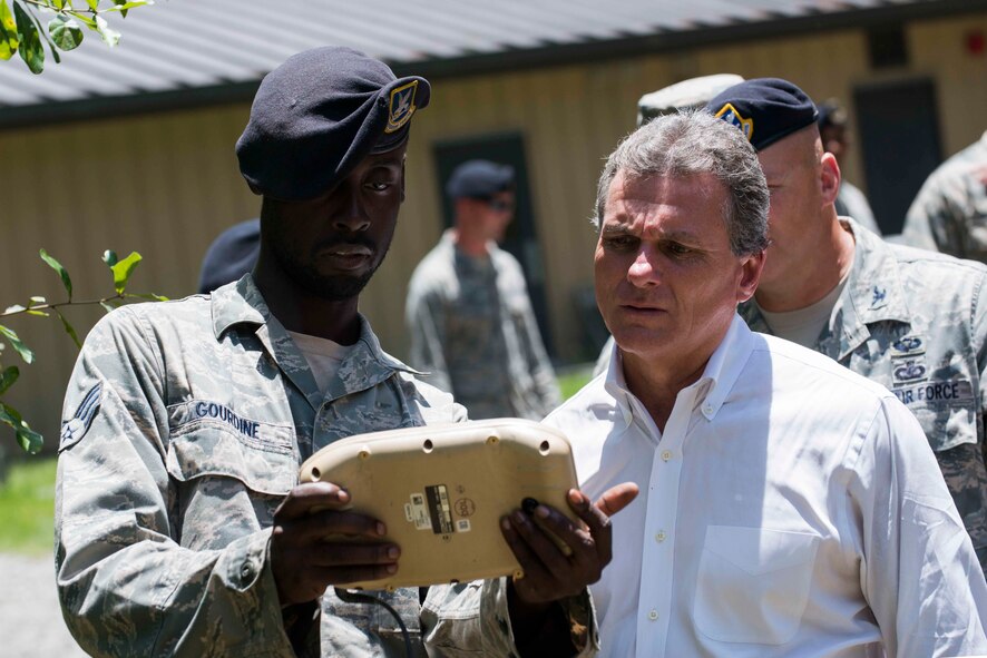 U.S. Air Force Senior Airman Jordan Gourdine, left, 820th Combat Operations Squadron technologies assistant, shows an RQ-11B Raven video feed to U.S. Rep. Buddy Carter of Georgia, during a base tour July 2, 2015, at Moody Air Force Base, Ga. The Raven gave Carter a different view of a sharpshooter demonstration. (U.S. Air Force photo by Airman 1st Class Dillian Bamman/Released)