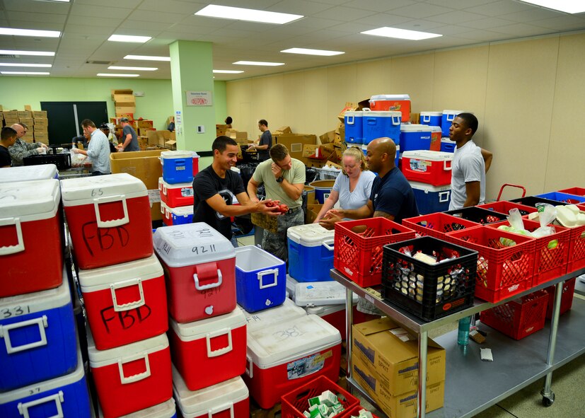 Team Dover Airmen unpack coolers of packaged meals July 6, 2015, at the Food Bank of Delaware in Milford, Del. The food will be repacked in Food Bank of Delaware coolers and distributed to children, families and seniors of Delaware. (U.S. Air Force photo/Airman 1st Class William Johnson)