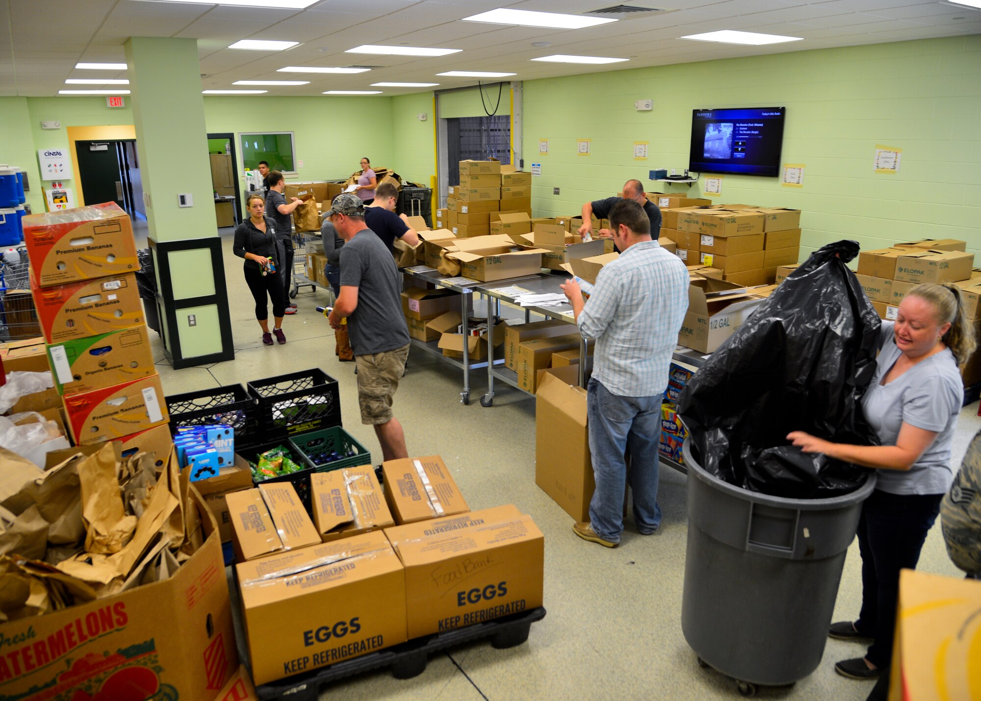 Team Dover Airmen sort and box more than 3,500 pounds of donated food July 6, 2015, at the Food Bank of Delaware in Milford, Del. The Food Bank of Delaware distributed more than 5 million pounds of food to Delawareans in need through shelters, soup kitchens and food closets. (U.S. Air Force photo/Airman 1st Class William Johnson)
