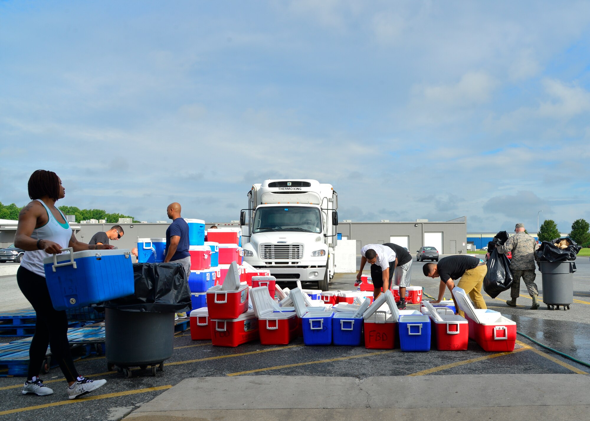 Team Dover Airmen clean the inside and outside of coolers used for the Children’s Nutrition Program July 6, 2015, at the Food Bank of Delaware in Milford, Del. The coolers are used to deliver more than 220 thousand meals to children in the Children’s Nutrition Program. (U.S. Air Force photo/Airman 1st Class William Johnson)