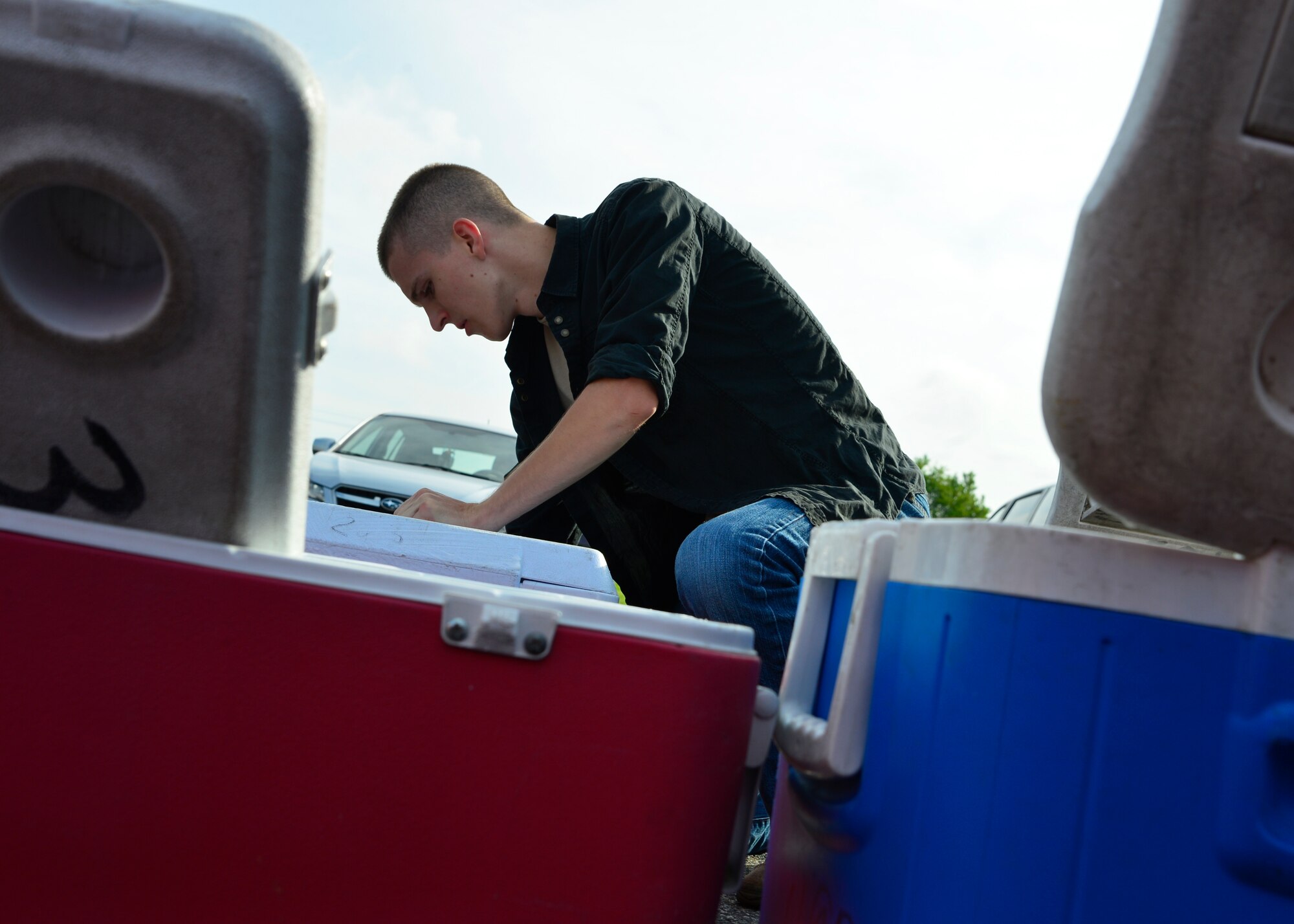 Airman 1st Class Shane Shafer, 436th Maintenance Squadron crew chief, cleans out a cooler to transport food July 6, 2015, at the Food Bank of Delaware in Milford, Del. More than 100 coolers were washed and are used in the Children’s Nutrition program to deliver after-school meals to at-risk children. (U.S. Air Force photo/Airman 1st Class William Johnson)