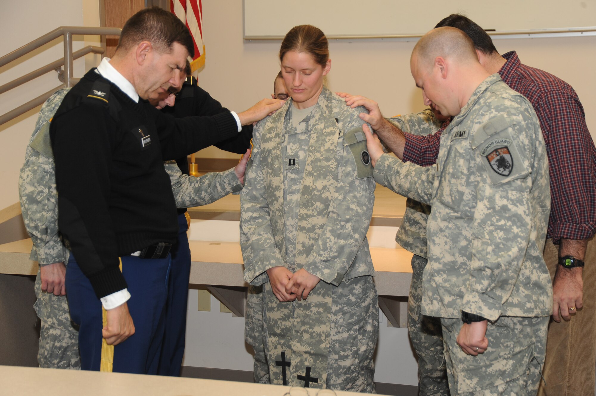 Colorado Army National Guard Chaplains surround Chaplain (Capt.) Mary St. Onge in prayer for her strength and to remind her she’s not alone in her ministry, at the Colorado National Guard headquarters in Centennial, Colo. As of Dec. 1, 2010, St. Onge is the COARNG’s newest chaplain and first female to hold the position in the entire CONG. St. Onge is assigned to the 193rd Military Police Battalion. (Official U.S. Air Force photo by Master Sgt. Cheresa D. Theiral, Colorado National Guard)
