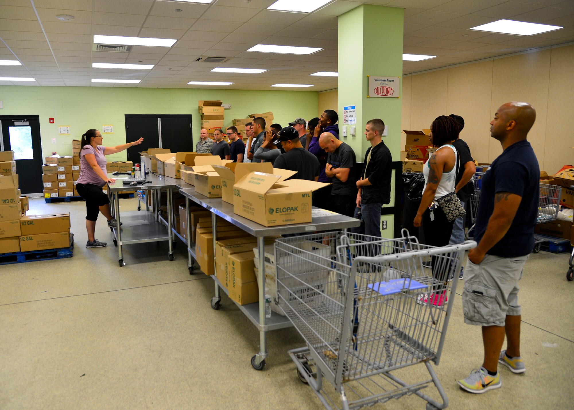 Lyndsay Humphreys, Food Bank of Delaware volunteer coordinator, briefs Team Dover Airmen on the food sorting procedures July 6, 2015, at the Food Bank of Delaware in Milford, Del. The Airmen volunteered to sort more than 3,500 pounds of donated food. (U.S. Air Force photo/Airman 1st Class William Johnson)