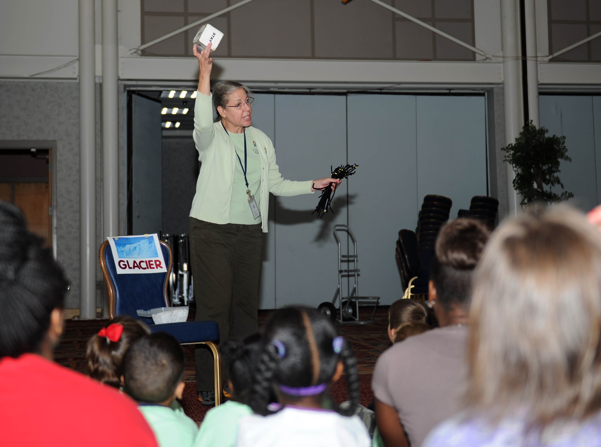 Kay Drennen, City of Wichita Public Works Environmental Health Water Center environmental specialist in water resources, teaches a water cycle lesson to youth, July 7, 2015, at McConnell Air Force Base, Kan. The base library staff hosted the event during one of several youth summer programs. (U.S. Air Force photo by Airman 1st Class Tara Fadenrecht)