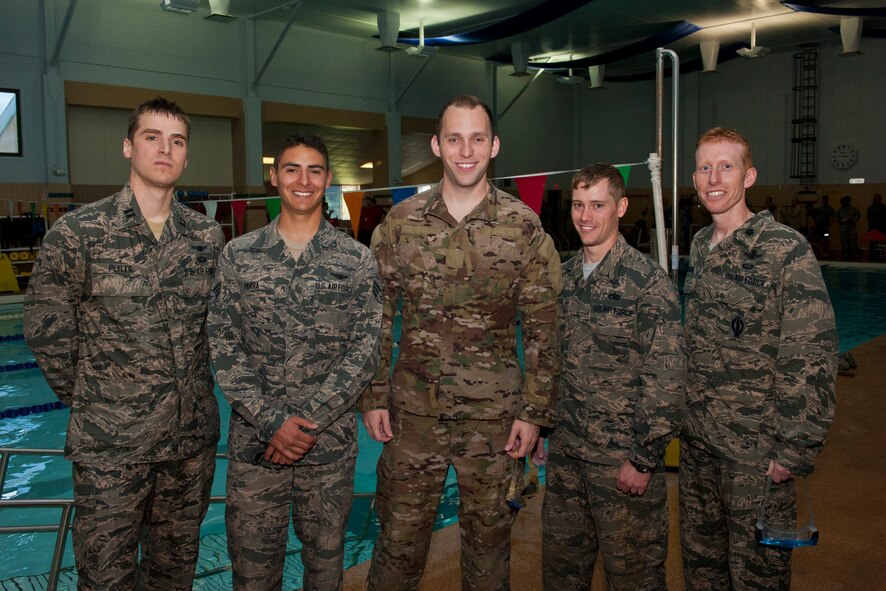 Airmen from the 2nd Space Operations Squadron pose for a team photo after the swimming portion of the qualification events for the German Armed Forces Proficiency Badge at Nelson Indoor Pool at Fort Carson June 30, 2015. The badge is awarded to German soldiers of all ranks as well as Allied service members, depending on the nation’s uniform regulations. To receive the award, service members had to meet minimum requirements in a basic fitness test (11 x 10 meter sprint, flexed arm hang, and 1,000 meter run), 100 meter swim in military uniform, marksmanship and a 12 km road march.(U.S. Air Force photo/Airman 1st Class Rose Gudex)