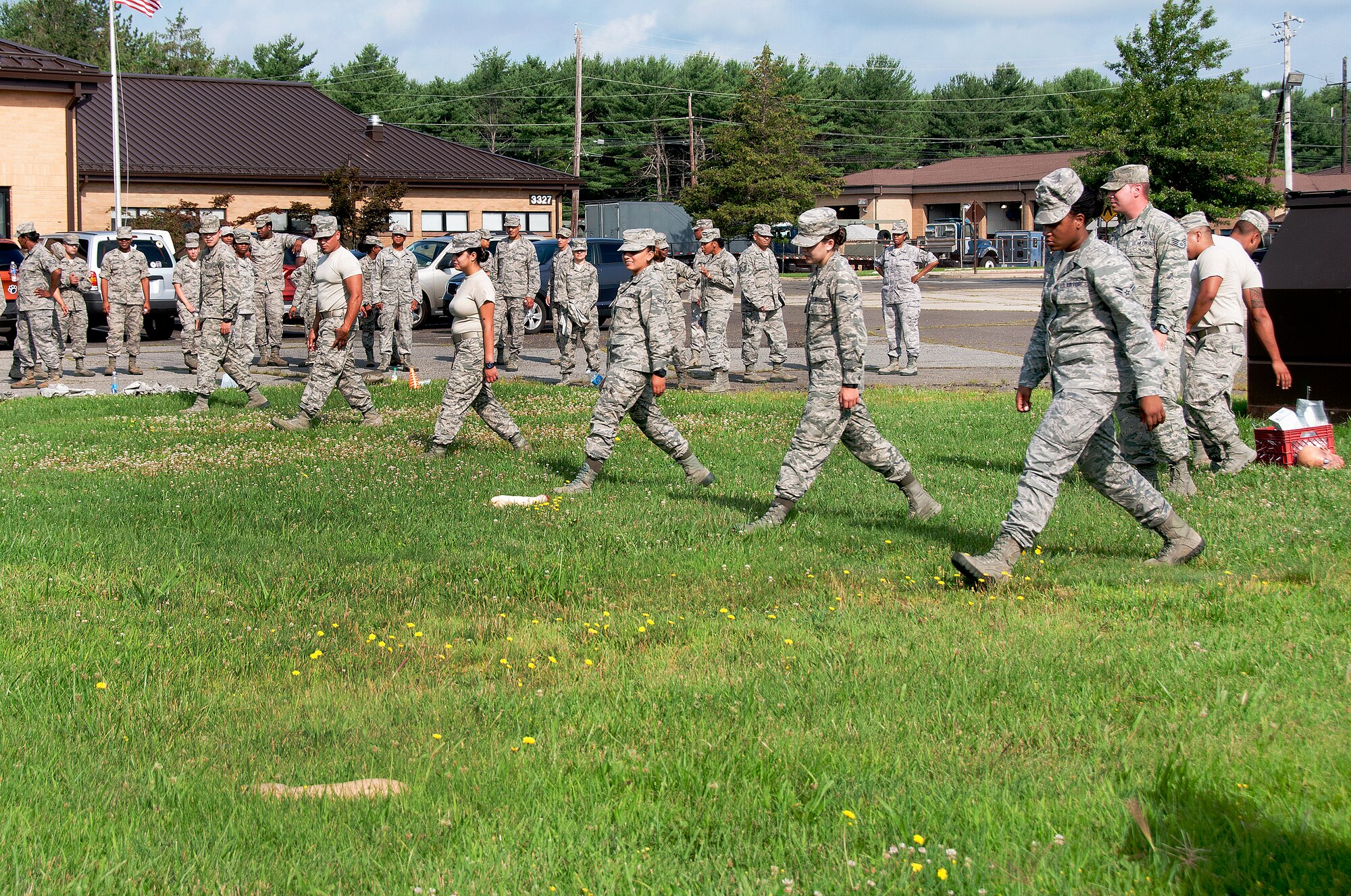 108th Force Support Squadron Airmen walk in a line to search for remains during an exercise at the unit's annual home-station training at Joint Base McGuire-Dix-Lakehurst, N.J., July 7, 2015. The training helped prepare Airmen to search and recover scattered remains over an area if a disaster took place, such as a plane crash. (U.S. Air National Guard photo by Airman 1st Class Julia Pyun/Released)