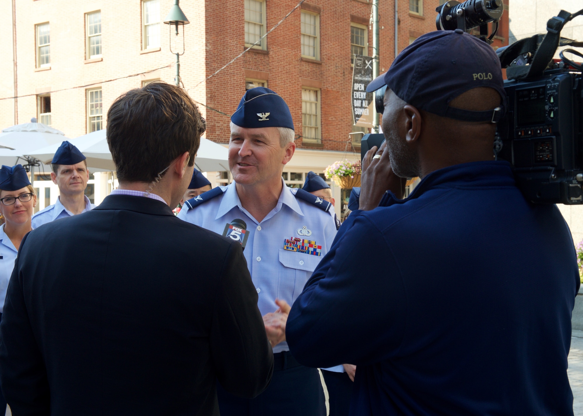 Col. Larry Lang, commander of the United States Air Force Band, is interviewed by Robert Moses during a live broadcast on Fox 5's "Good Day New York."  The interview was part of a performance on the local morning show by the Singing Sergeants, one of six performing ensembles from the United States Air Force Band in Washington. (U.S. Air Force photo by Senior Master Sgt. Bob Kamholz/released)
