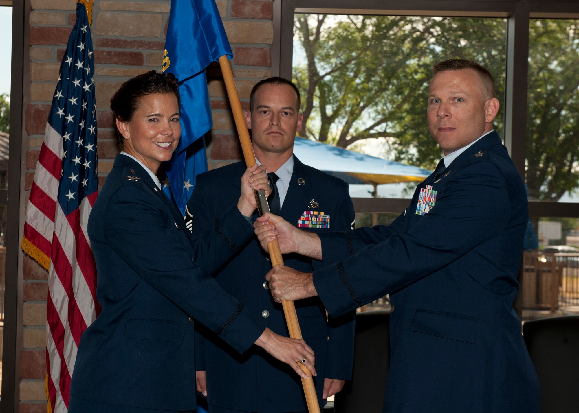 Lt. Col. Elbert Alford, the incoming 49th Medical Support Squadron commander, receives the unit’s guidon from Col. Leslie A. Knight, the 49th Medical Group commander, during the unit’s change of command ceremony at Holloman Air Force Base, N.M., July 7, 2015. Alford will lead the unit’s 77 active duty and civilian personnel who maintain the operation of all medical support activities, medical readiness items, facility management, and pharmacy operations. (U.S. Air Force photo by Senior Airman Chase Cannon/Released)