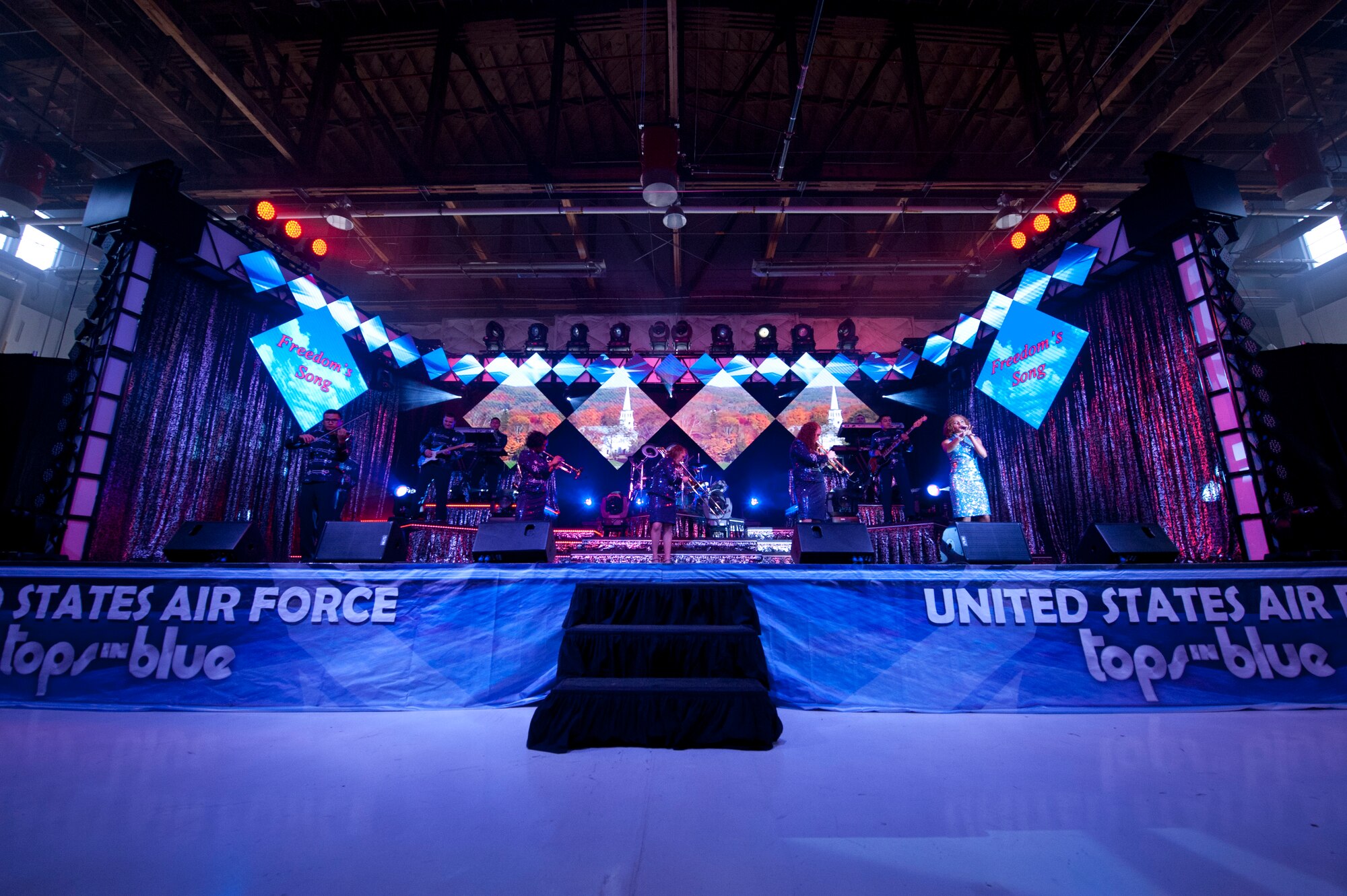 PETERSON AIR FORCE BASE, Colo. – Tops in Blue puts on a show for Peterson Airmen and their families at Hangar 140, July 1, 2015. The performers are active duty Airmen who compete in a multilevel competition to be selected for the Tops in Blue team. The team trains for 60 days at Joint Base San Antonio-Lackland Air Force Base, Texas, before touring to 20 countries and performing 75 shows in seven months. (U.S. Air Force photo by Airman 1st Class Rose Gudex)