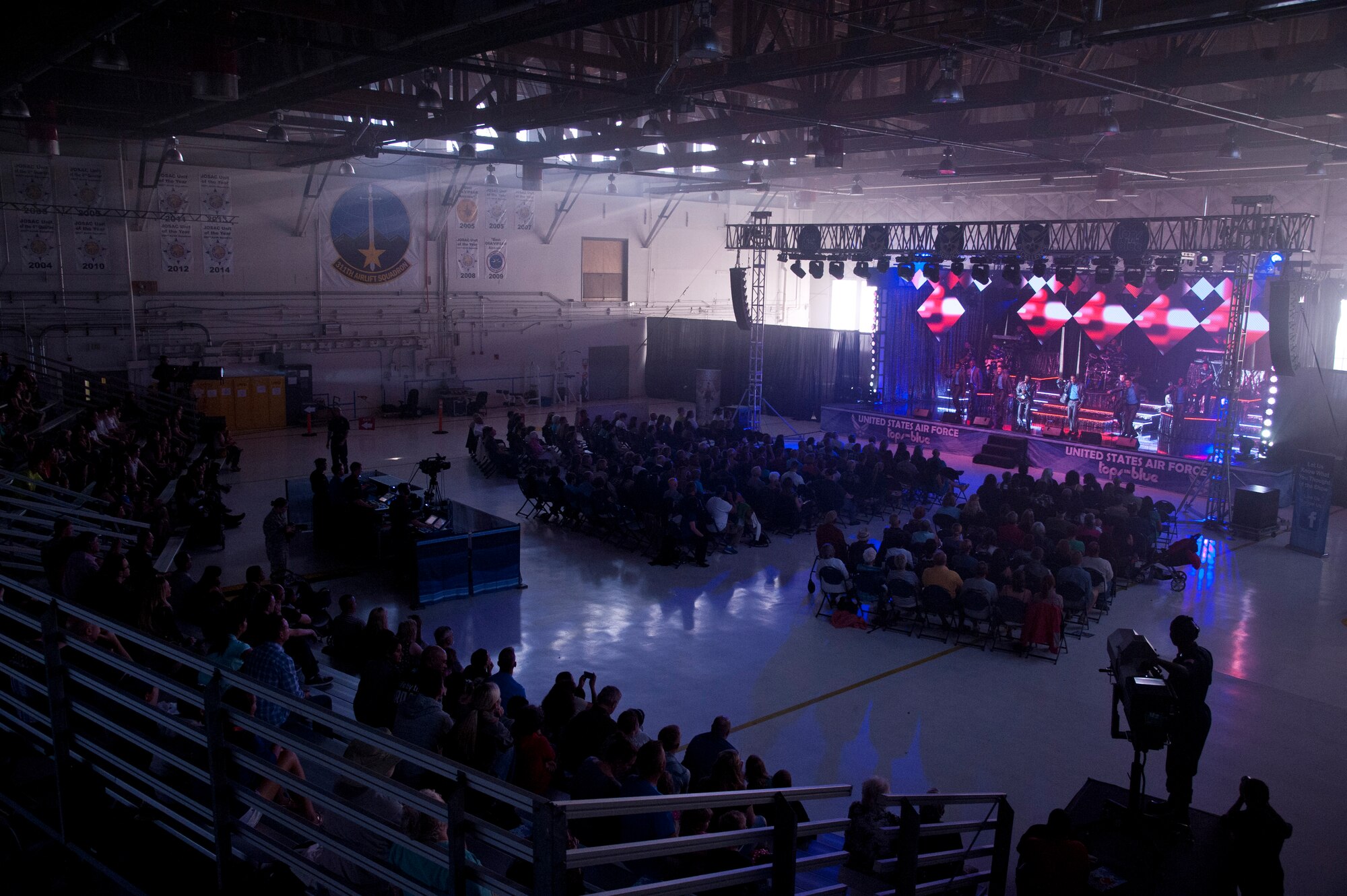 PETERSON AIR FORCE BASE, Colo. – Tops in Blue performs for Air Force personnel and their families at Hangar 140, July 1, 2015. The performers serve as an expeditionary entertainment unit to provide quality entertainment from within Air Force resources for the Air Force family, with priority to Air Force personnel stationed worldwide at remote and deployed locations, while simultaneously promoting community relations, supporting recruiting efforts and serving as ambassadors for the United States of America and the U.S. Air Force. (U.S. Air Force photo by Senior Airman Tiffany DeNault)