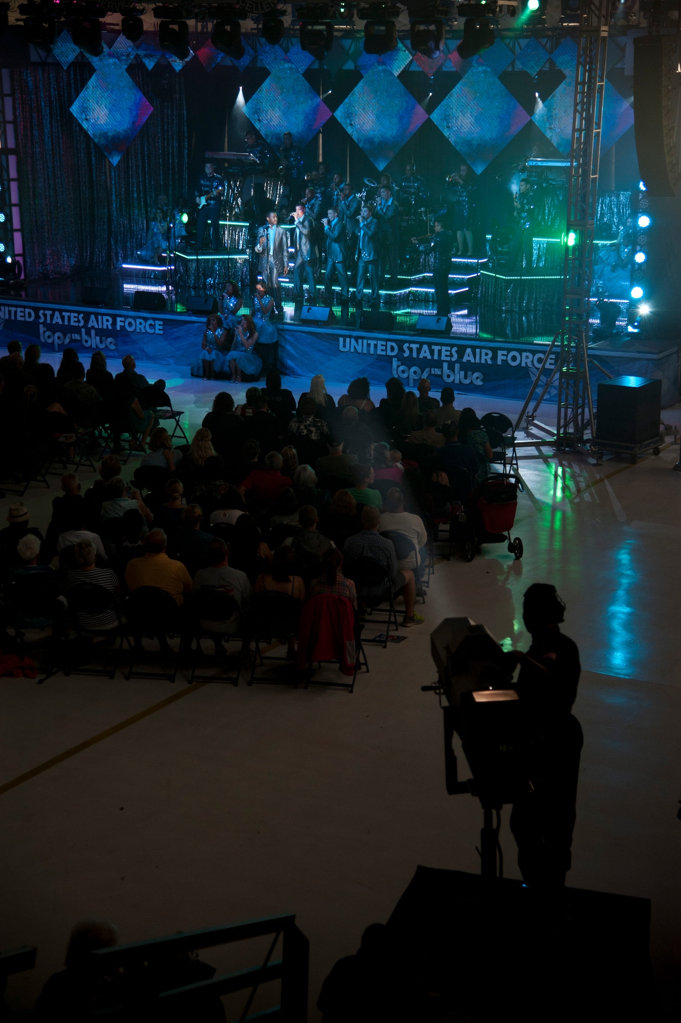 PETERSON AIR FORCE BASE, Colo. – Tops in Blue performs for Air Force personnel and their families at Hangar 140, July 1, 2015. The performers compete in a multilevel competition to be selected for the Tops in Blue team and then complete a 60-day training period at Joint Base San Antonio-Lackland Air Force Base, Texas, before touring to 20 countries, performing 75 shows in seven months. (U.S. Air Force photo by Senior Airman Tiffany DeNault)