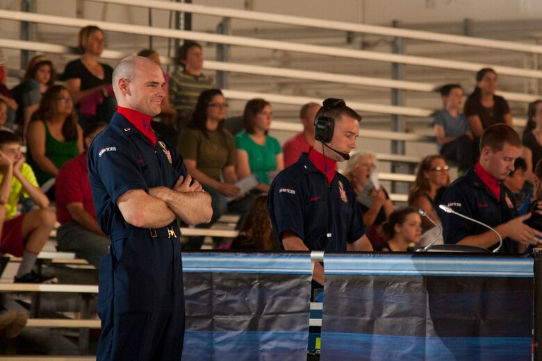 PETERSON AIR FORCE BASE, Colo. – 1st Lt. Ethan Frazier, 21st Force Support Squadron chief of military personnel and Tops in Blue technical director, smiles as he watches the Tops in Blue Performance at Hangar 140, July 1, 2015. Frazier’s passion for entertainment production began six years before joining the Air Force, and he seized an opportunity to be a technical director for Tops in Blue, teaching other Airmen lighting, audio, video and staging techniques. (U.S. Air Force Senior Airman Tiffany DeNault)