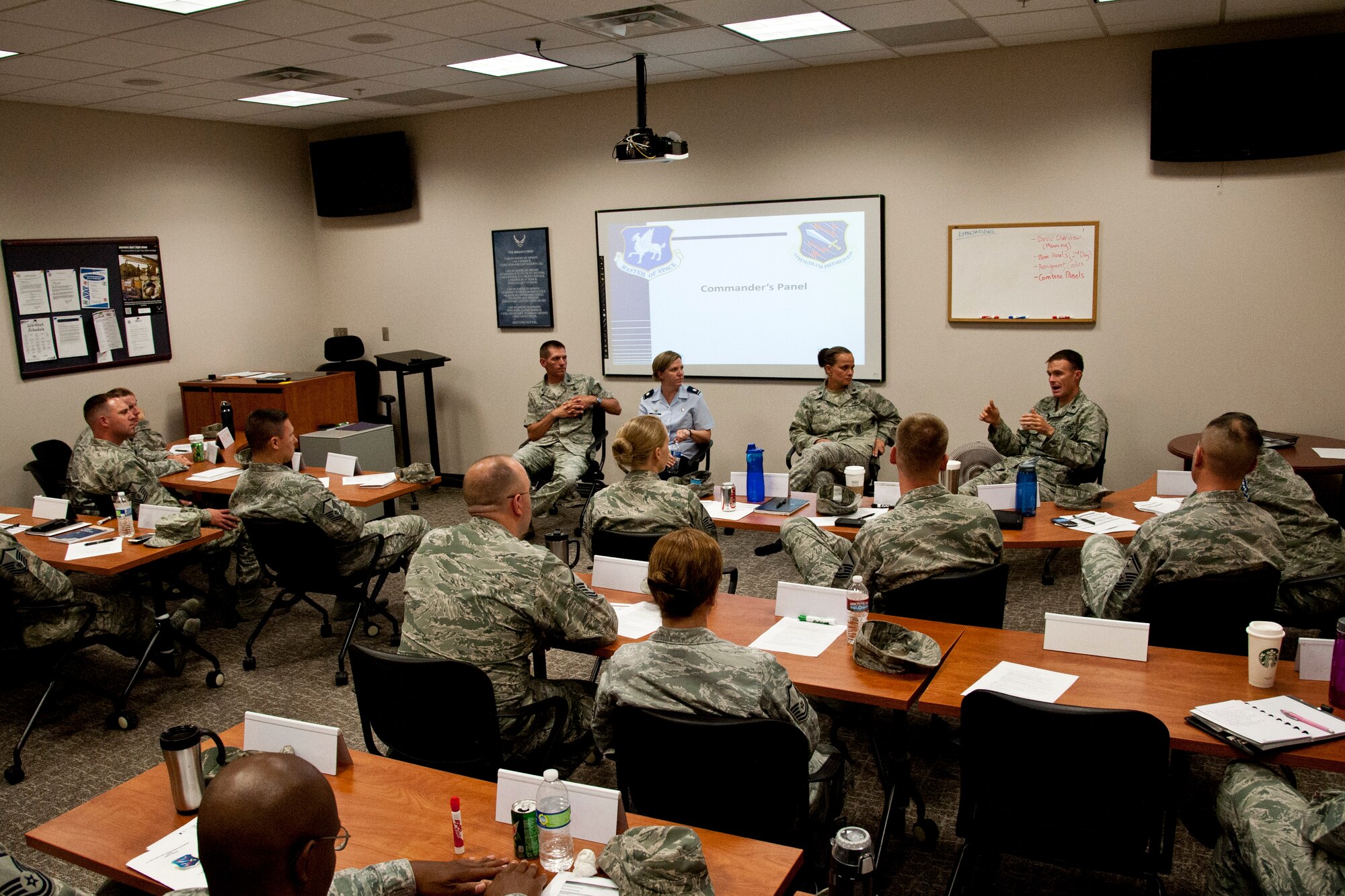 PETERSON AIR FORCE BASE, Colo. – Peterson and Schriever Air Force Base group commanders talk to students in the superintendent course about the working relationship between the commander, first sergeant and superintendent, June 30, 2015. Senior Master Sgt. Darren Williams, 1st Space Operations Squadron superintendent and Senior Master Sgt. Patricia Ford, 50th Space Control Squadron superintendent, brought the class to Peterson with the intent of teaching senior NCOs how to excel as a superintendent. (U.S. Air Force photo by Senior Airman Tiffany DeNault)