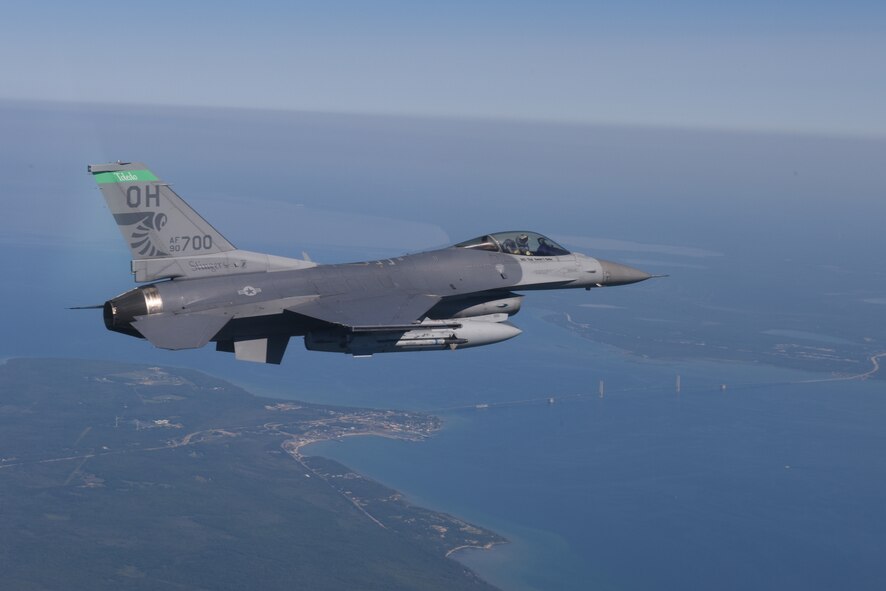 U.S. Air Force Capt. Roy Poor, an F-16 Fighting Falcon pilot, flies over the Mackinac Bridge and Mackinac Island during a training sortie June 26, 2015. The 180th Fighter Wing was performing multiple training sorties over Lake Huron and Northern Michigan June 21-24. (Air National Guard photo by Tech. Sgt. Amber Williams/Released)