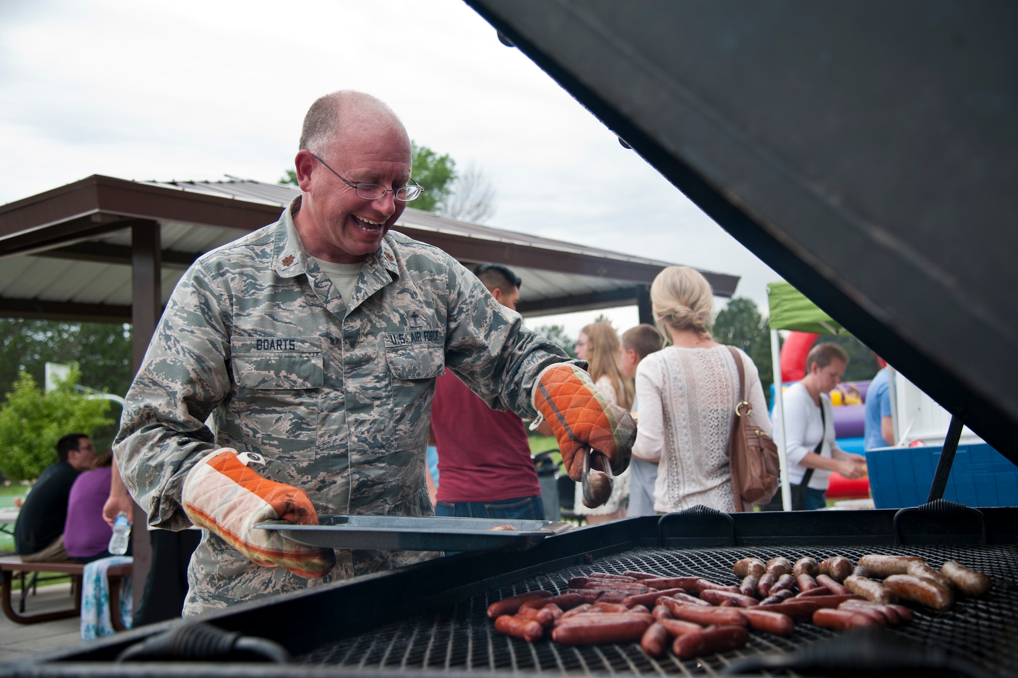 PETERSON AIR FORCE BASE, Colo. – Maj. Matthew Boarts, 21st Space Wing chaplain, grills the hot dogs, sausages and hamburgers during the Peterson Chapel’s community cook out at the Tierra Vista community center, July 2, 2015. The Chapel kicked off the July Fourth weekend with approximately 200 Team Pete members and their families with grilled food, games and music. (U.S. Air Force photo by Senior Airman Tiffany DeNault)