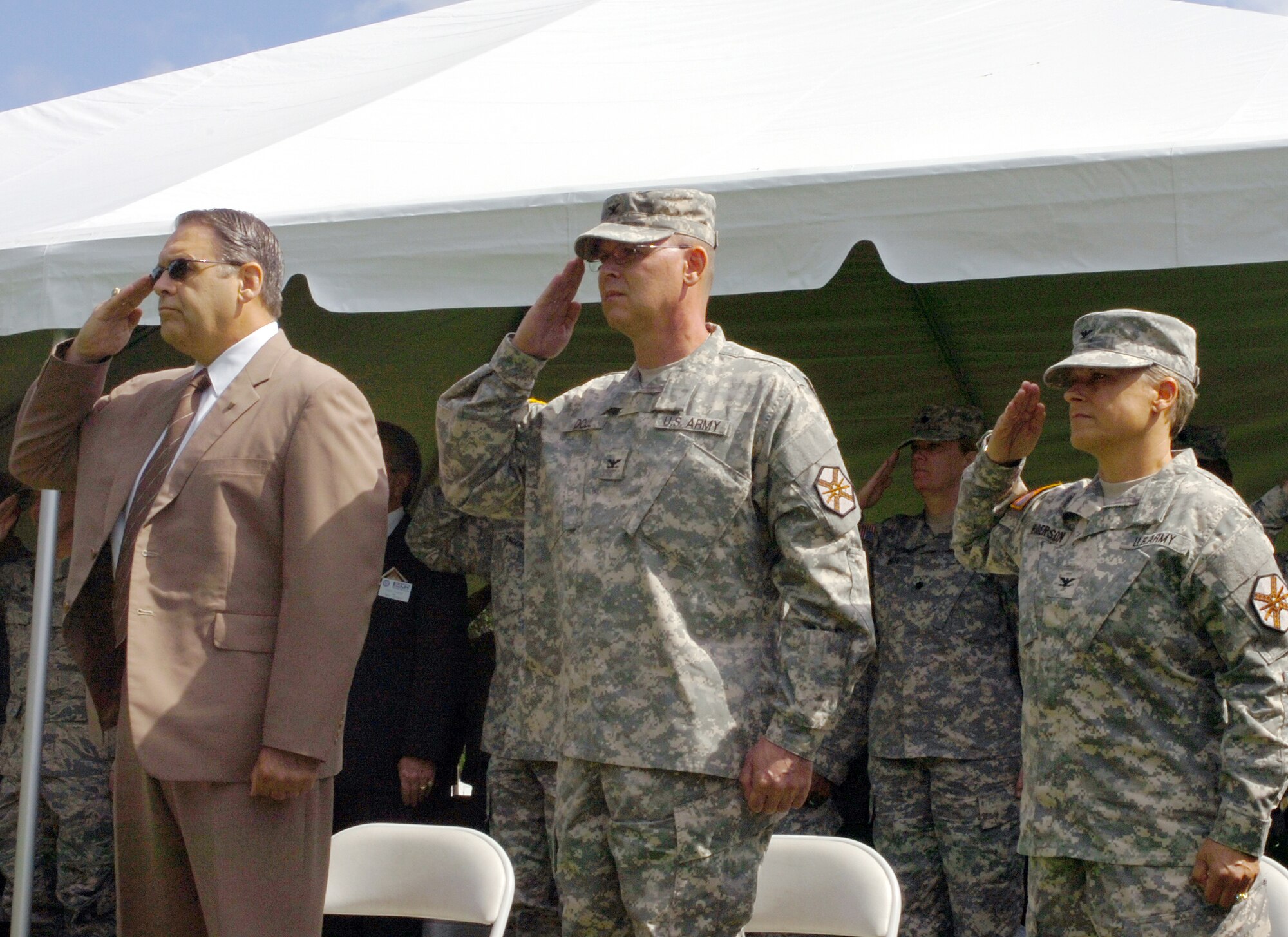 Davis Tindoll, U.S. Army Installation Management Command region director, Col. Jeffrey Doll, and Col. Shelley Balderson, salute during the playing of the National Anthem as part of the U.S. Army Support Activity-Dix change of command ceremony at Joint Base McGuire Dix Lakehurst, N.J., June 29, 2015. Doll passed the command to Balderson during the ceremony held at the Army Reserve Museum on JB MDL. (U.S. Army photo by David F. Moore/Released)