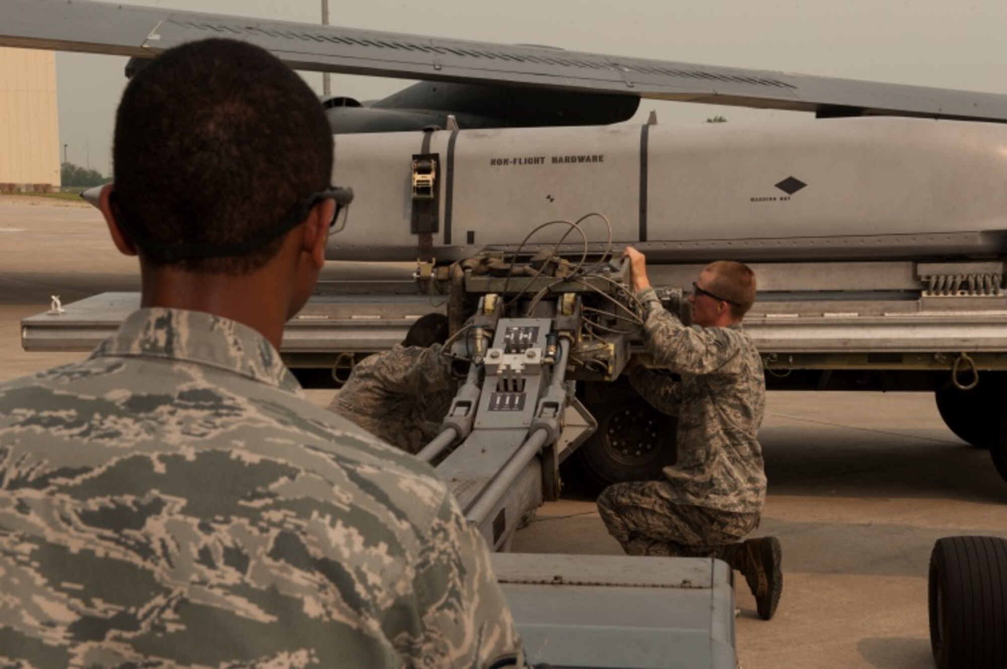 Airmen from the 5th Aircraft Maintenance Squadron load inert AGM-158 missiles onto a B-52H Stratofortress during the Load Crew of the Quarter competition at Minot Air Force Base, N.D., July 1, 2015. The competition is comprised of four parts: dress and appearance, a loader’s knowledge test, toolbox inspection and the timed missile load.  The first of two four-man crews to participate was led by Staff Sgt. Demeterius White, a 5th Maintenance Squadron load crew chief. (U.S. Air Force photos/ Airman 1st Class Christian Sullivan and Airman 1st Class Justin T. Armstrong)