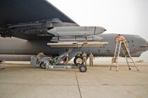 Airmen from the 5th Aircraft Maintenance Squadron load an inert AGM-158 missile onto a B-52H Stratofortress using a MHU-83 during the Load Crew of the Quarter competition at Minot Air Force Base, N.D., July 1, 2015.  The competition is comprised of four parts: dress and appearance, a loader’s knowledge test, toolbox inspection and the timed missile load.  (U.S. Air Force photo/ Airman 1st Class Justin T. Armstrong)