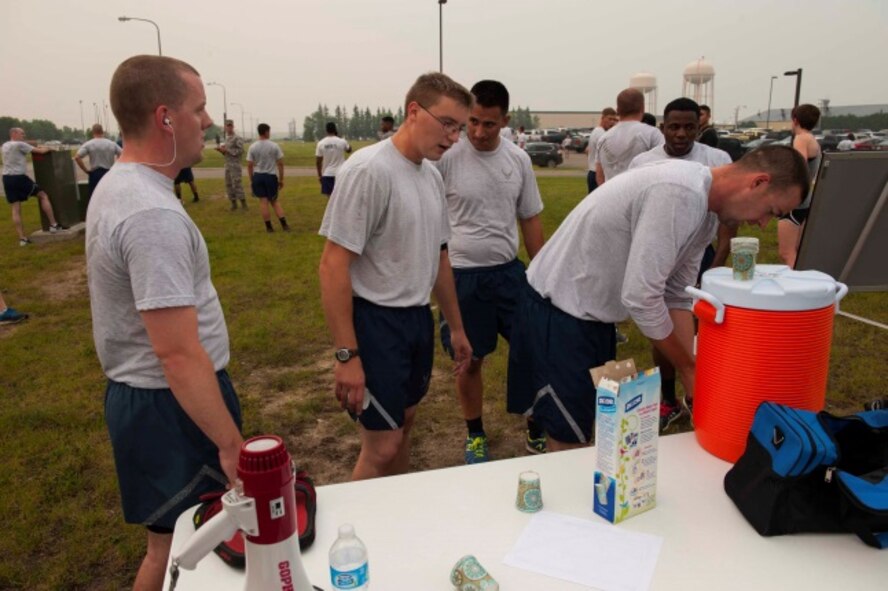 Airmen quench their thirst after the Firecracker 5K at Minot Air Force Base, N.D., July 2, 2015. Runners made a loop around the base for the course of the run. (U.S. Air Force photo/Airman 1st Class Christian Sullivan)