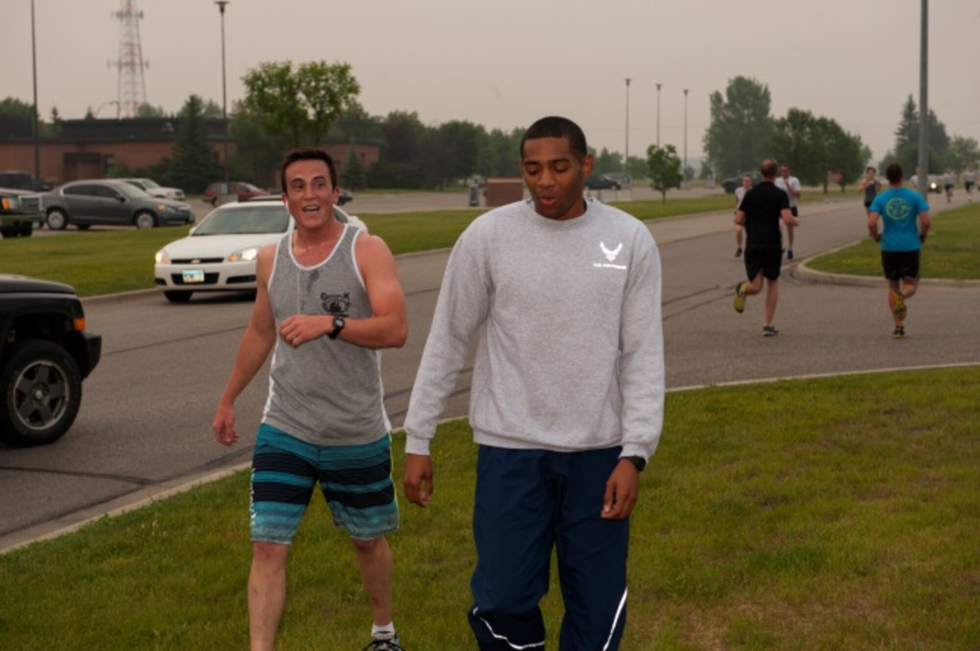 Airmen finally cross the finish line after the Firecracker 5K at Minot Air Force Base, N.D., July 2, 2015. The fitness center tries to host about one to two runs or special events a month to keep military personnel and their families participating in the community. (U.S. Air Force photo/Airman 1st Class Christian Sullivan)